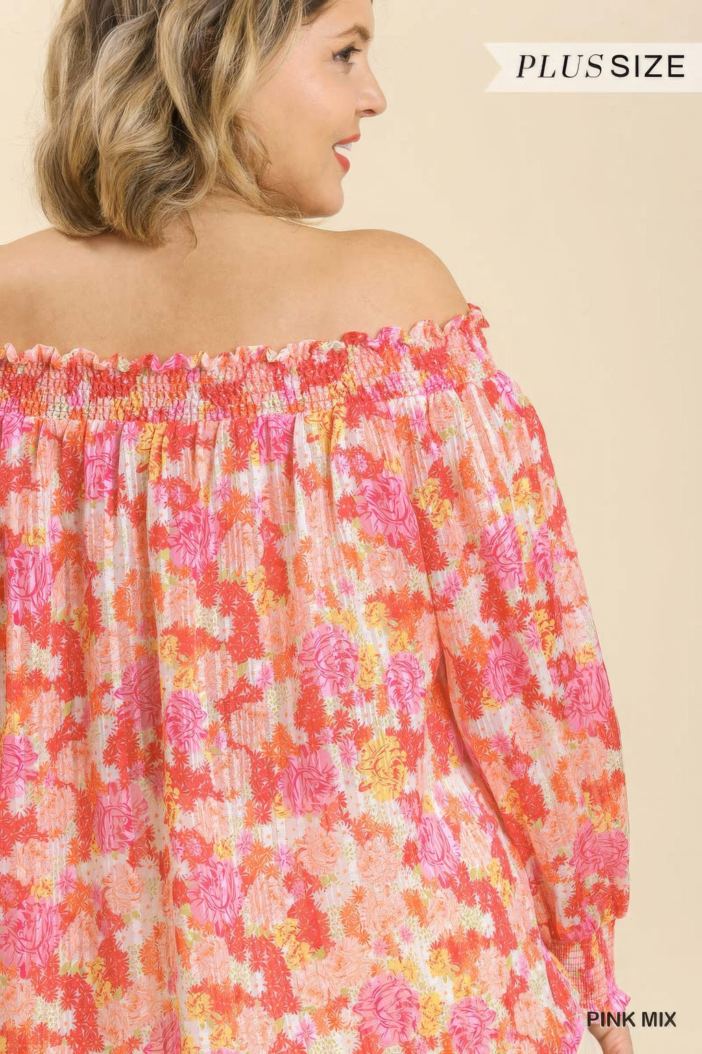 Back of pink-mix off-shoulder floral top with long puff sleeves and smocked band