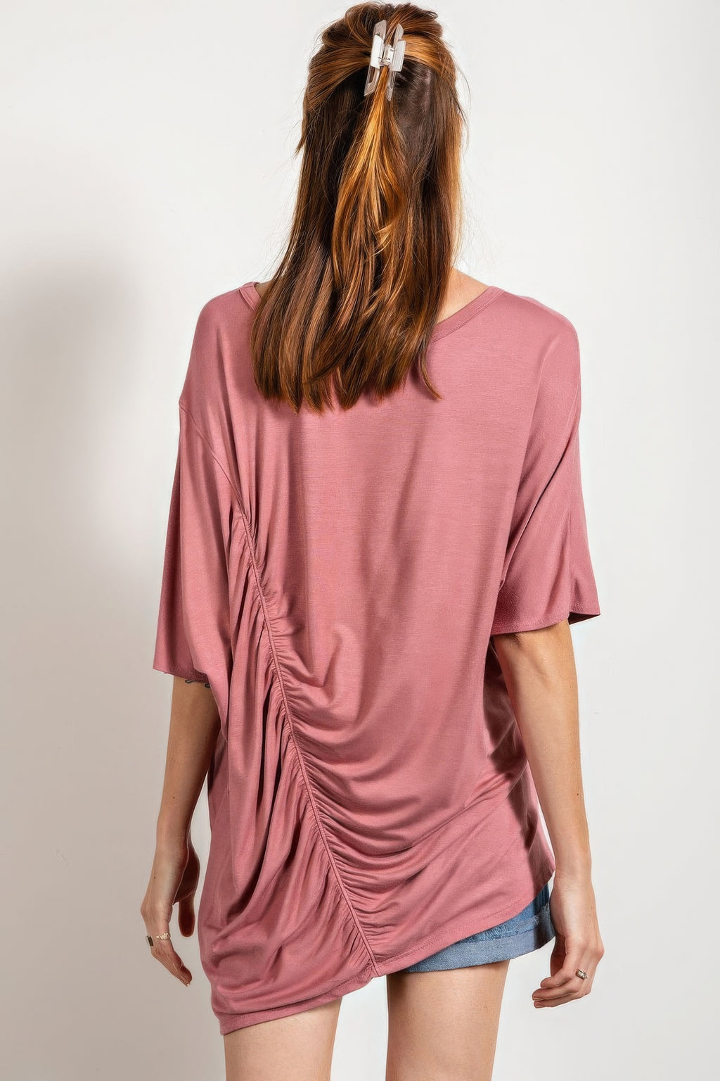Back view of mauve loose-fit top with ruched side seam detail