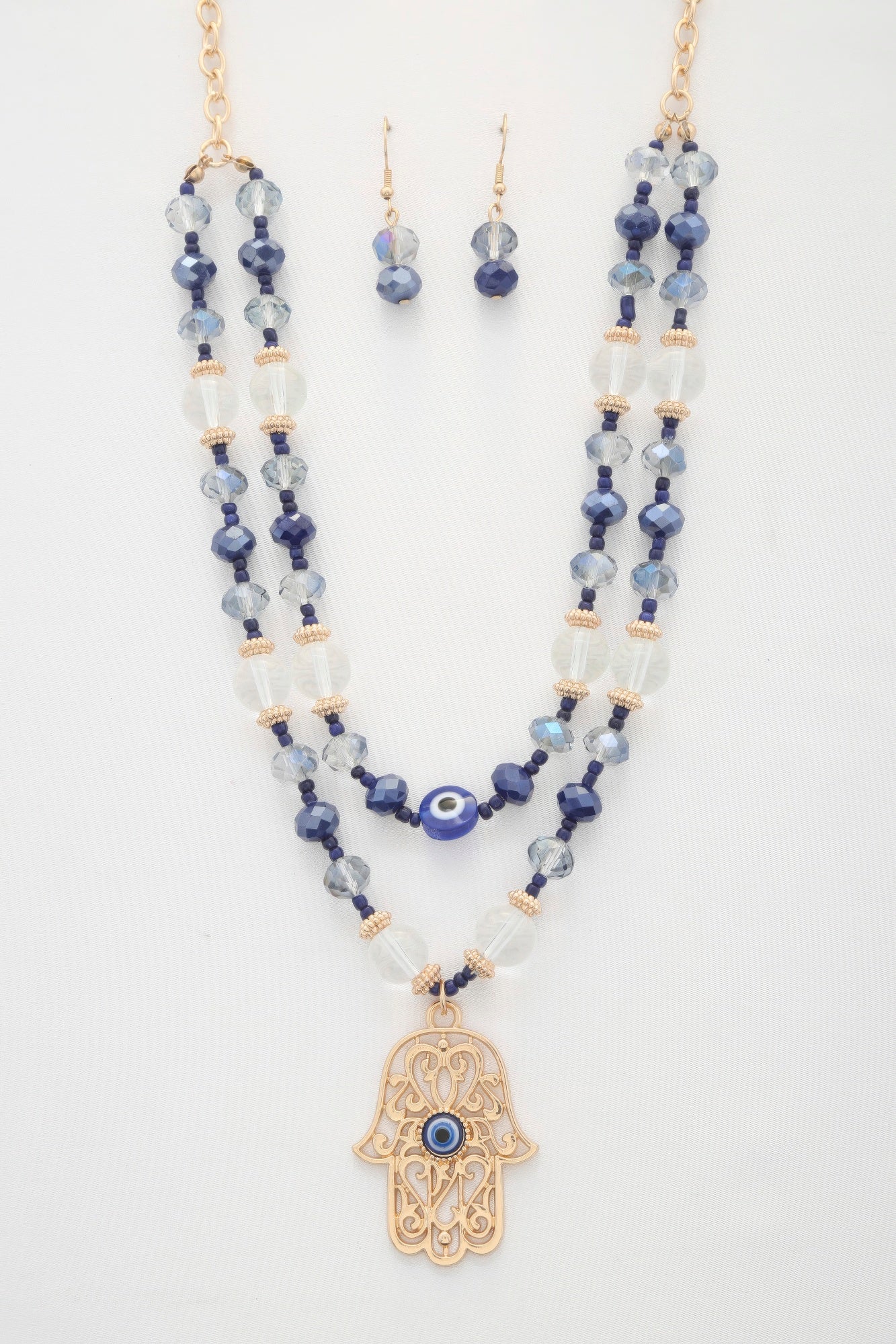 Hamsa hand pendant layered necklace with blue bead strands and evil-eye charm
