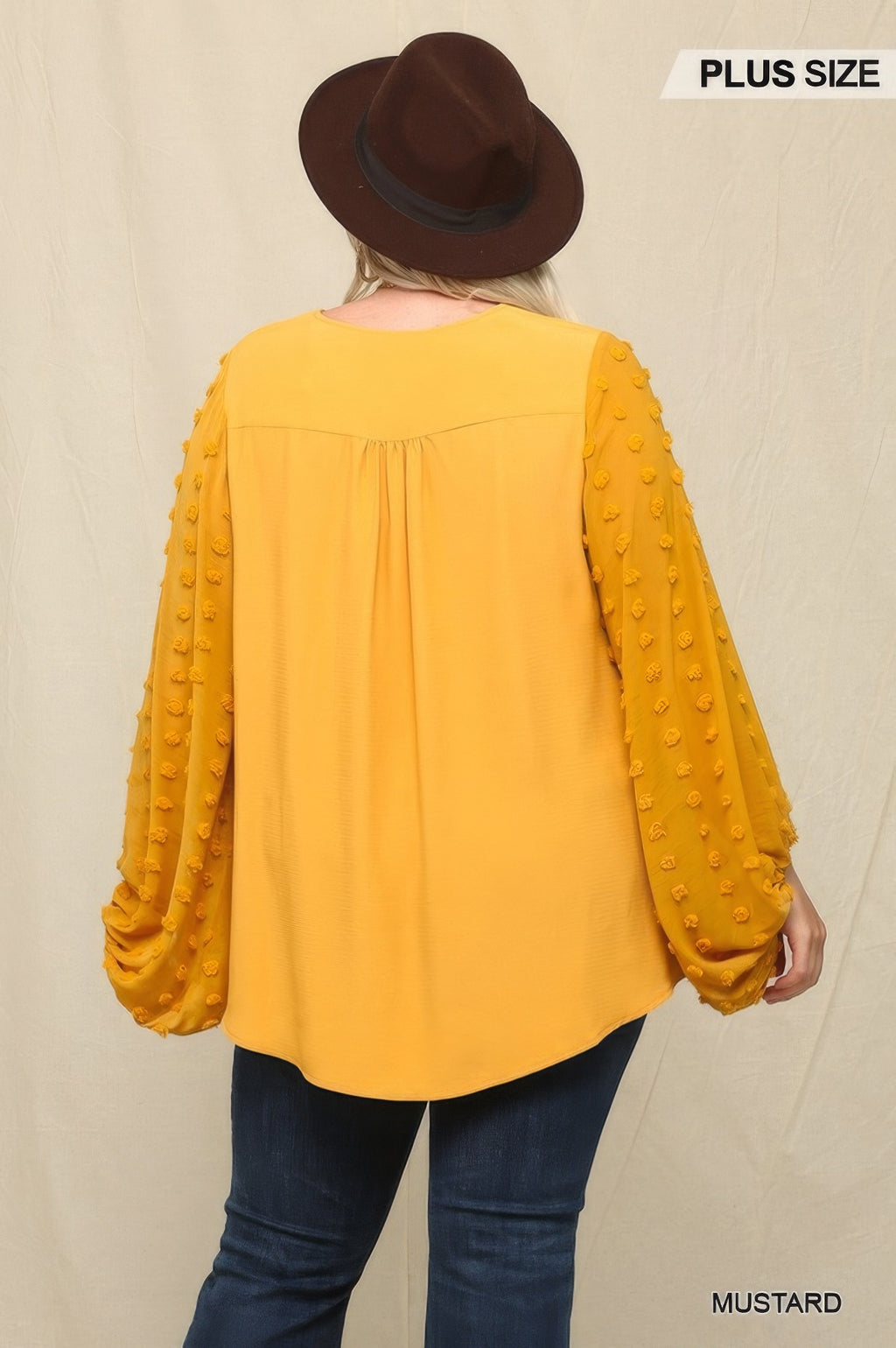 Back view: mustard chiffon top with gathered sheer textured sleeves