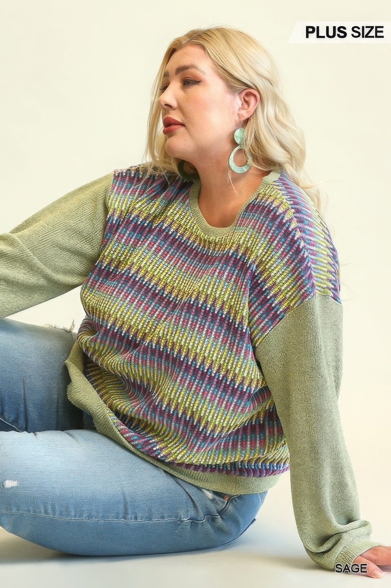 Sage knit top detail: rainbow stripe yoke with solid green sleeves and relaxed fit