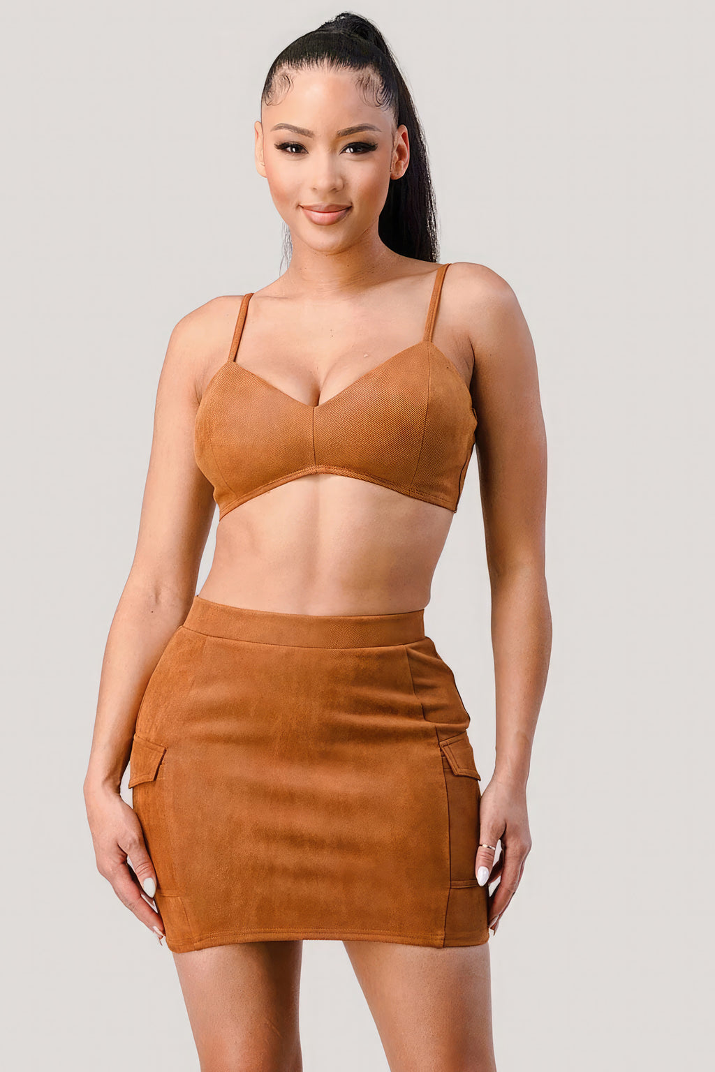 Tan strappy bralette with cropped jacket and fitted mini skirt set