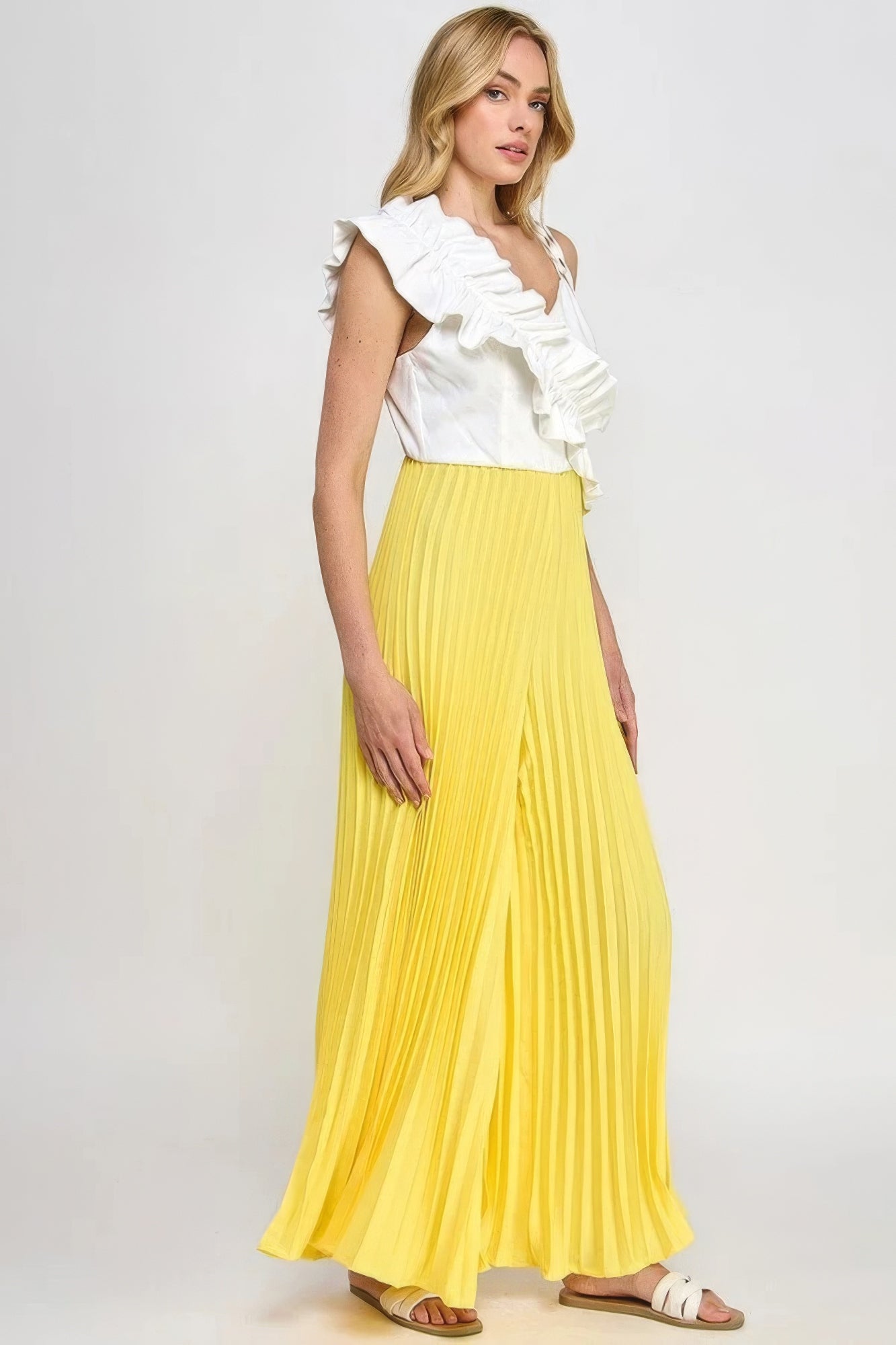 Cami jumpsuit, white ruffle shoulder detail over yellow pleated flowing wide legs
