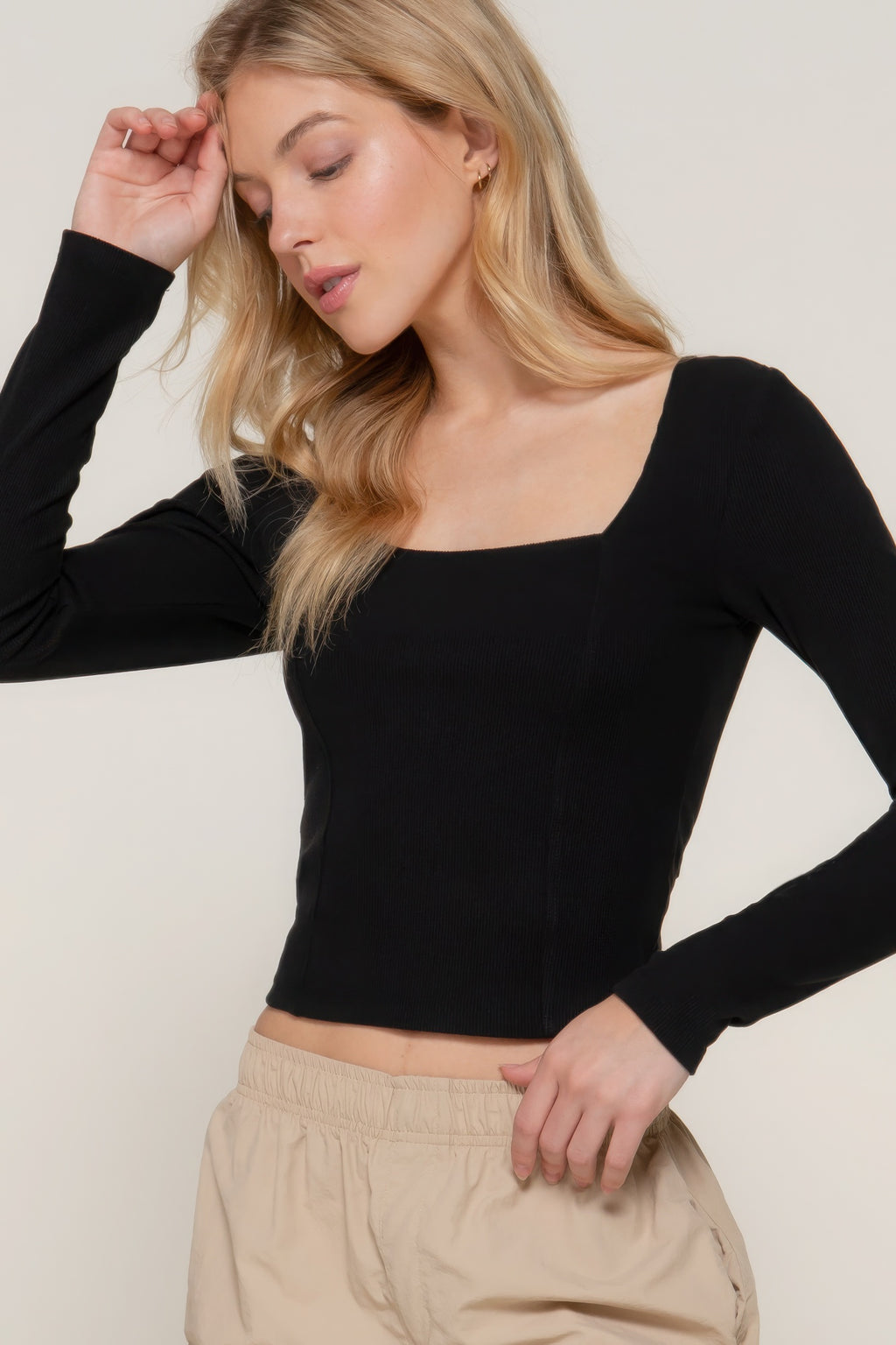 Black long-sleeve knit top with sweetheart neckline and seam detail