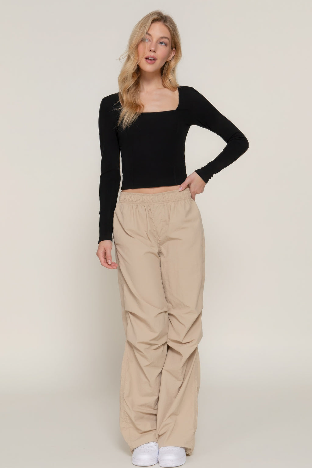 Black long-sleeve knit top with sweetheart neckline, fitted bodice