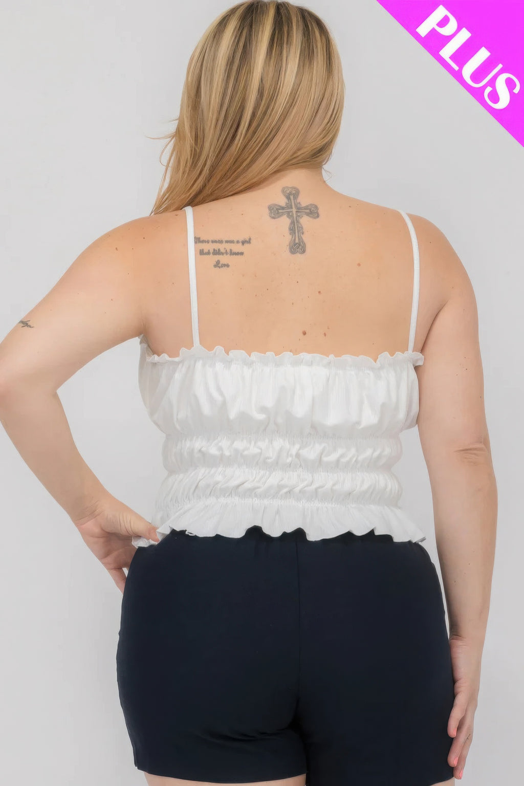 Back view of white tiered shirred body crop top with thin spaghetti straps