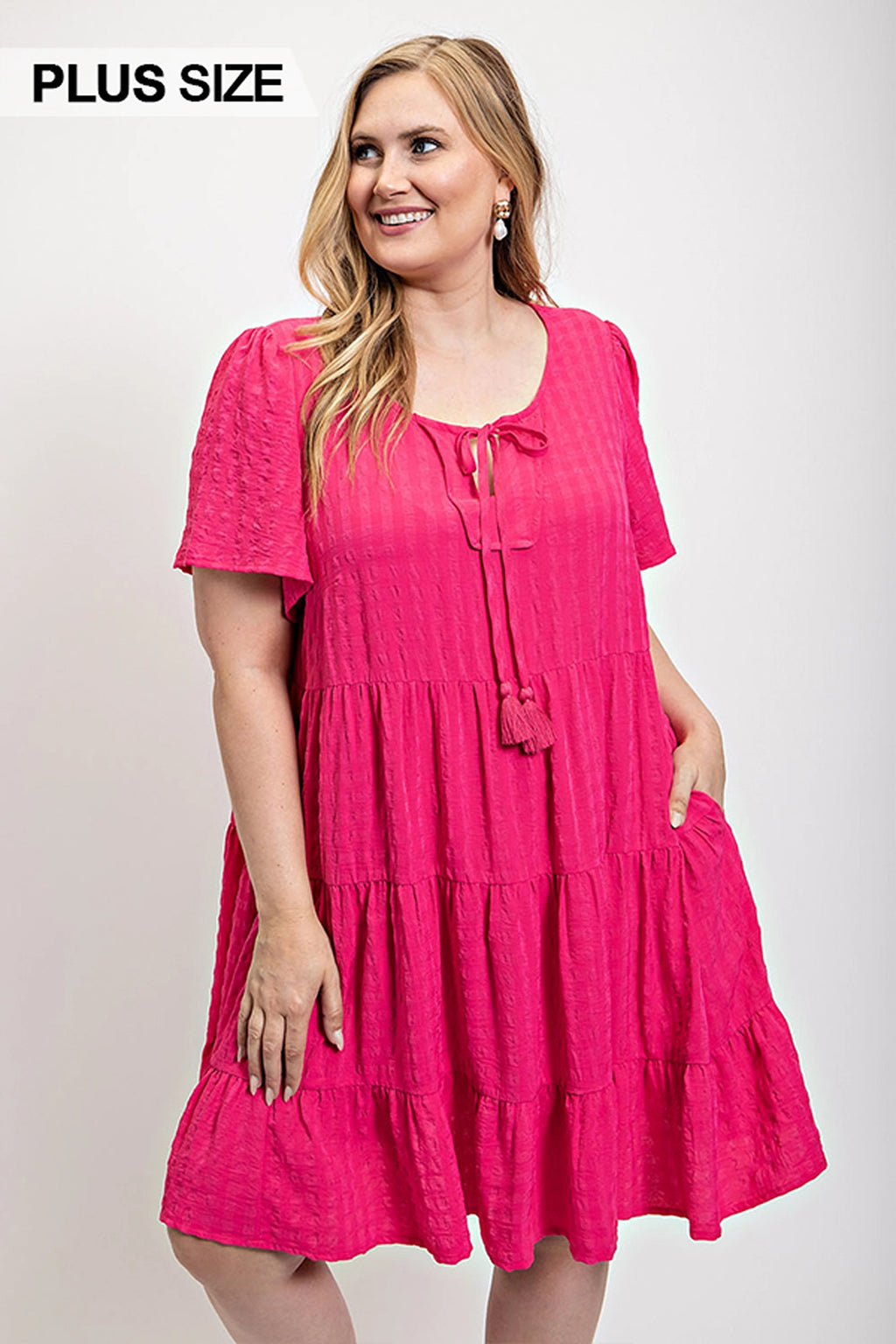 Textured fuchsia tiered dress with tassel-tie neckline and side pockets