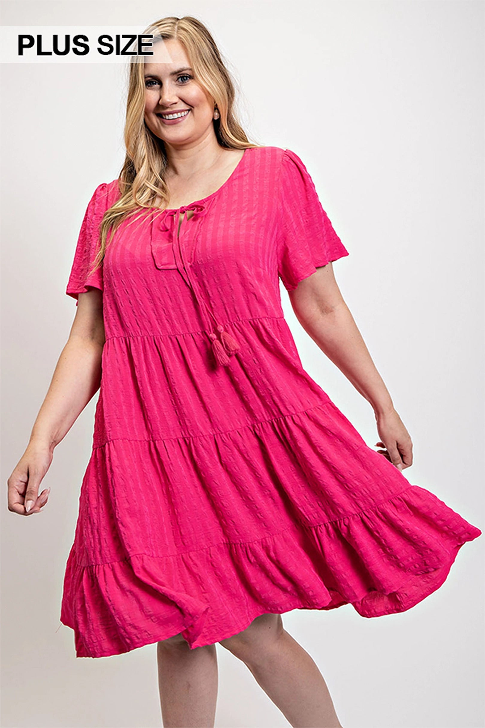 Textured fuchsia tiered dress with tassel-tie neckline and flutter sleeves