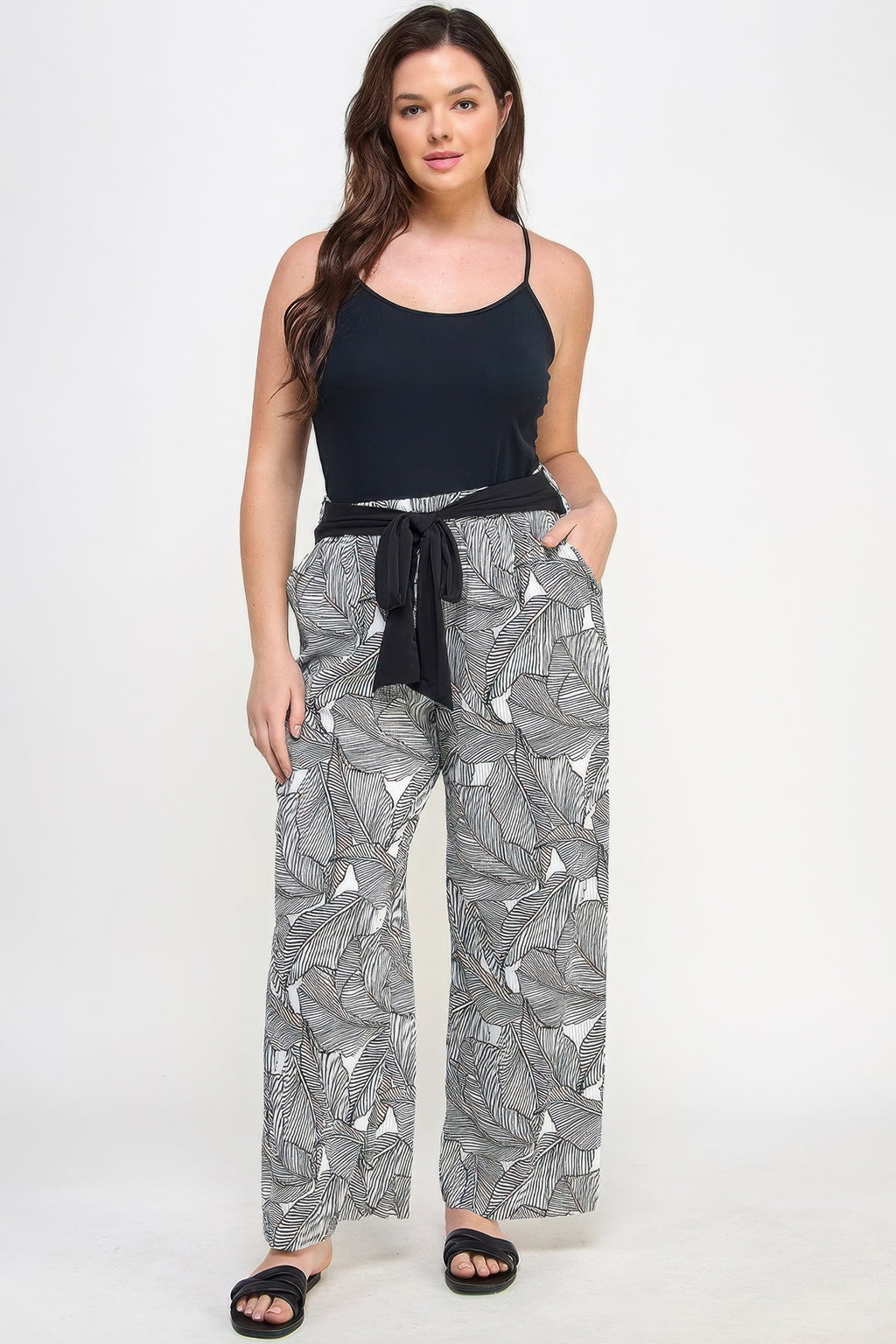 Plisse palm print pants with black elastic waistband and drawstring, wide-leg leaf print