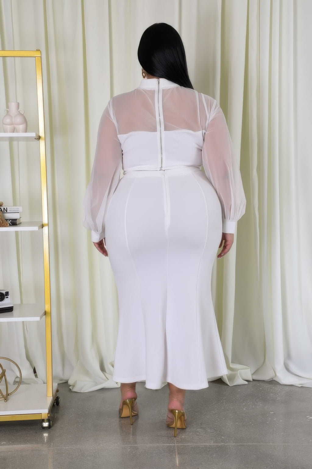 White stretch skirt set back view: sheer long sleeves with seam detail on fitted skirt