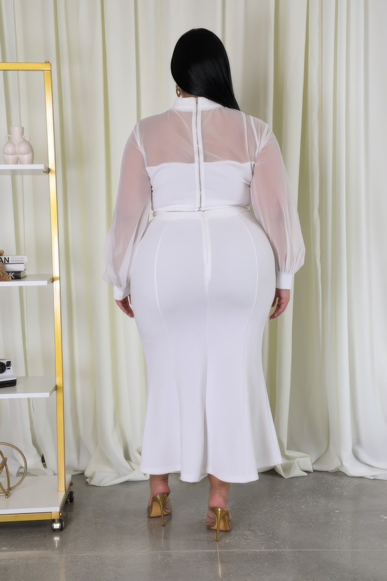 White stretch skirt set back view: sheer long sleeves with seam detail on fitted skirt