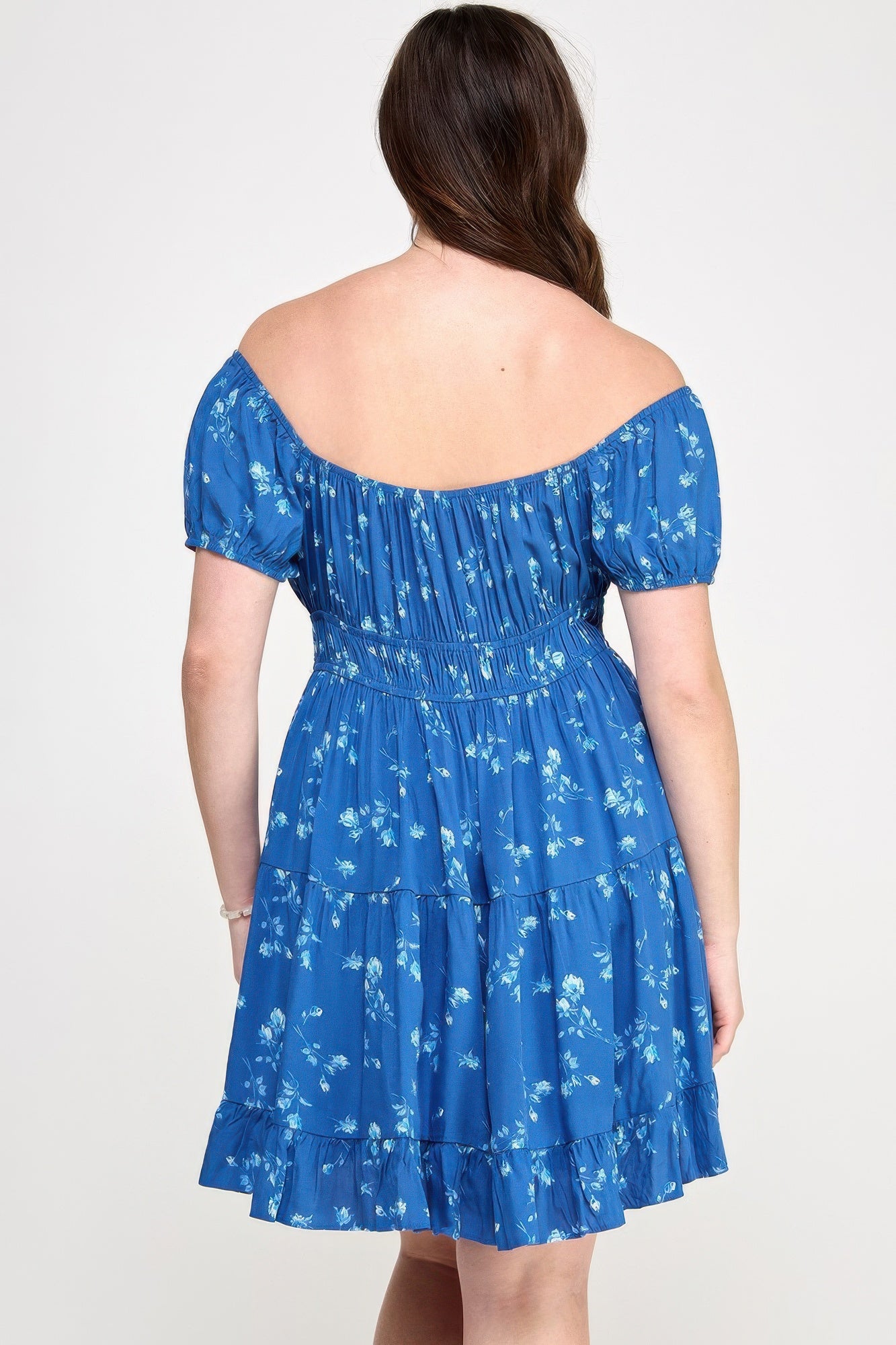 Rear view: blue floral tiered ruffle mini dress with elastic waist and short puff sleeves