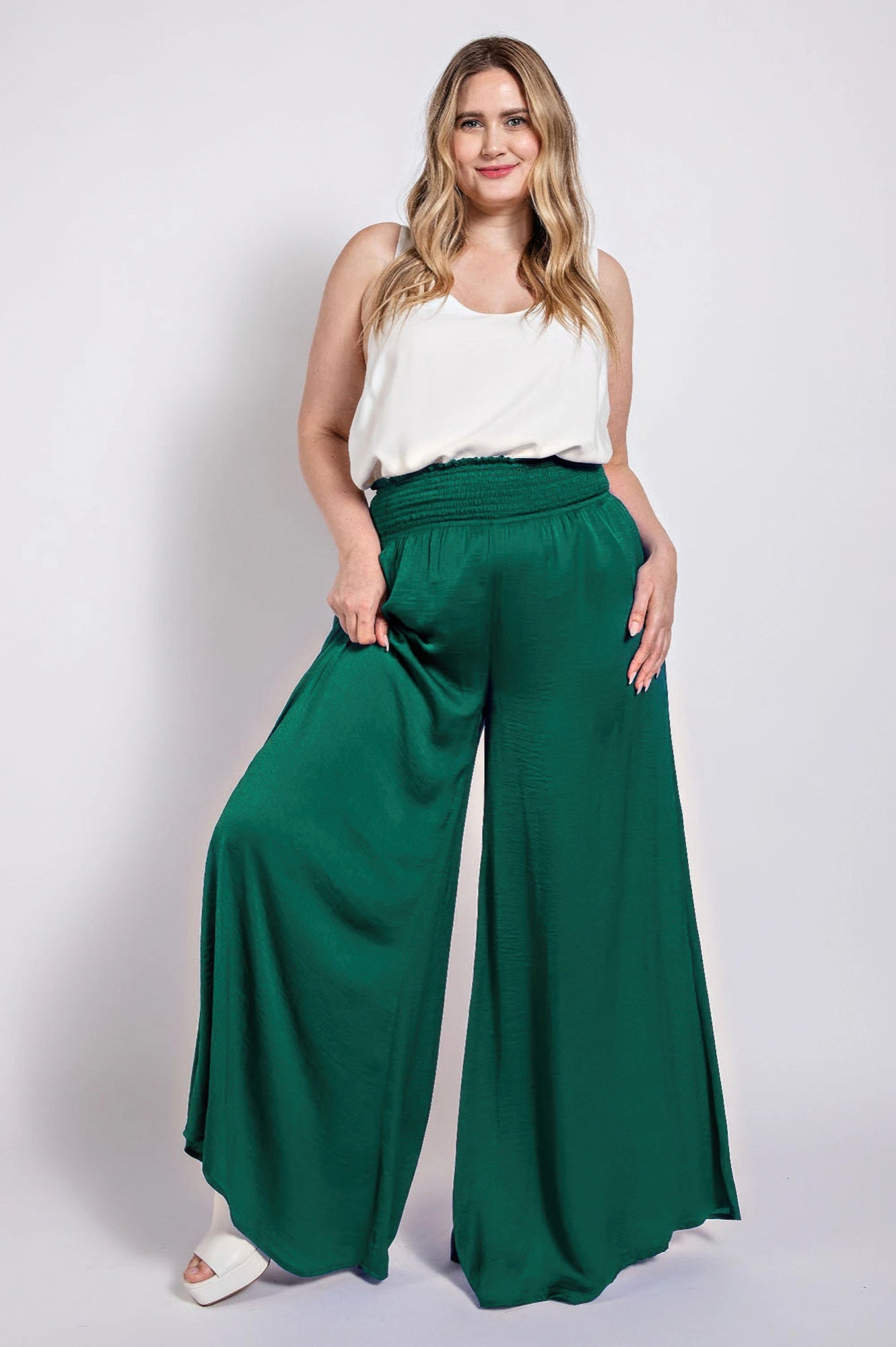 Emerald green washed satin wide-leg pants with smocked elastic waistband