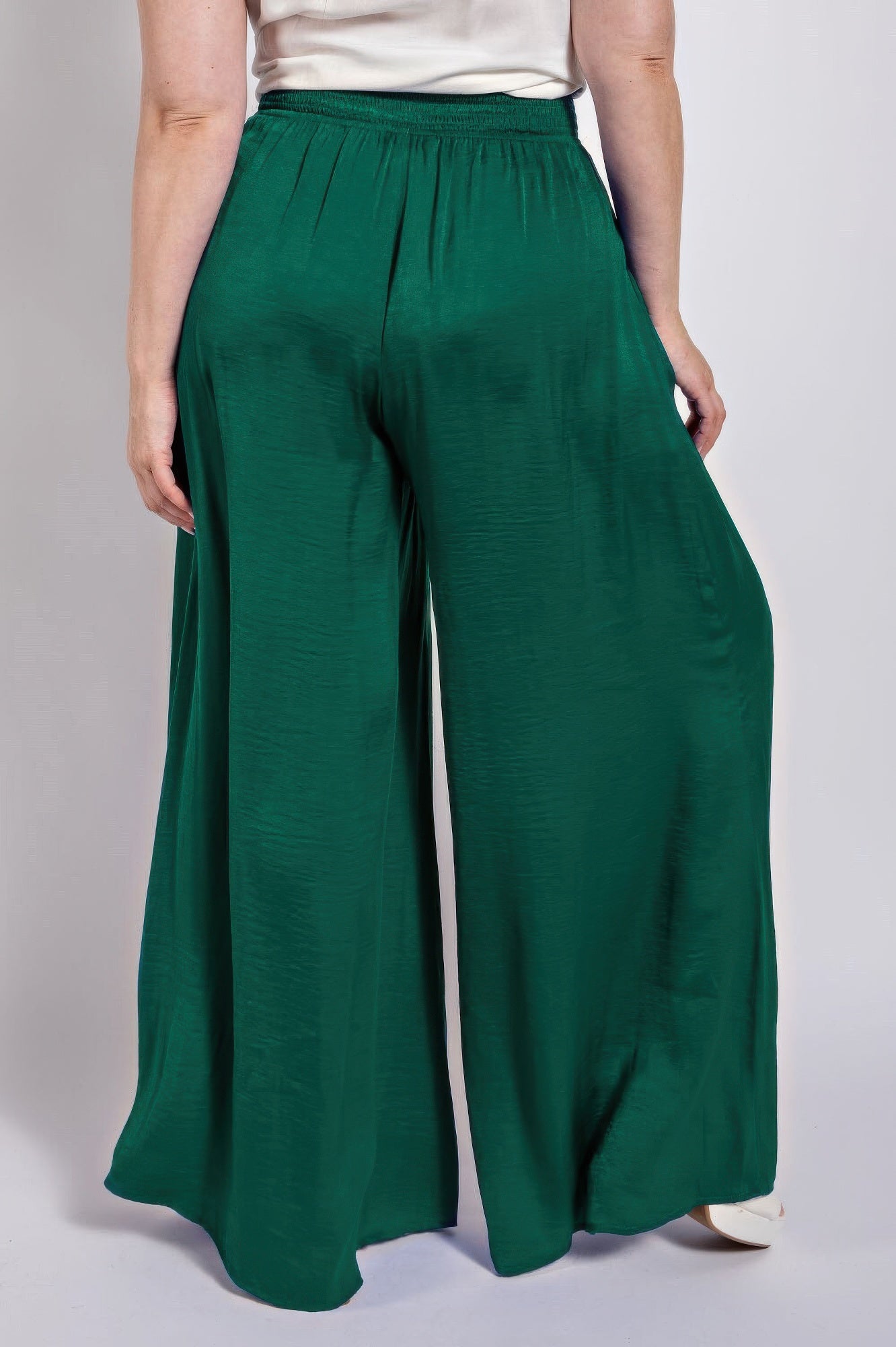 Emerald green washed satin wide pants with smocked waist and full-length wide legs