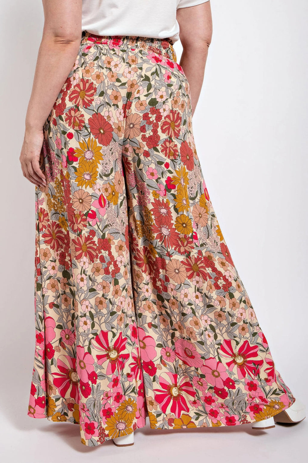 Front view: multicolor floral wide-leg pants with smocked waist and pockets