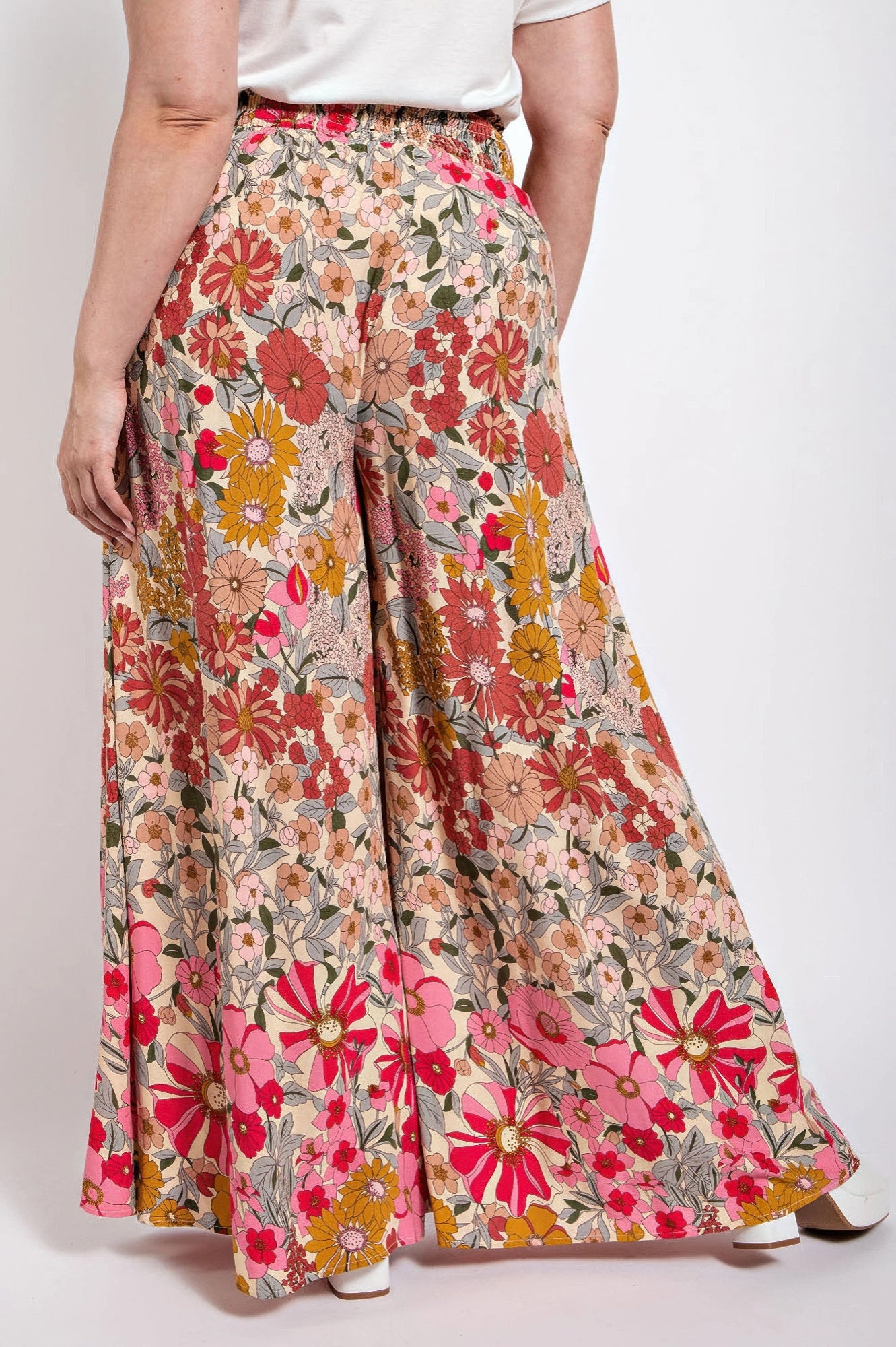 Front view: multicolor floral wide-leg pants with smocked waist and pockets