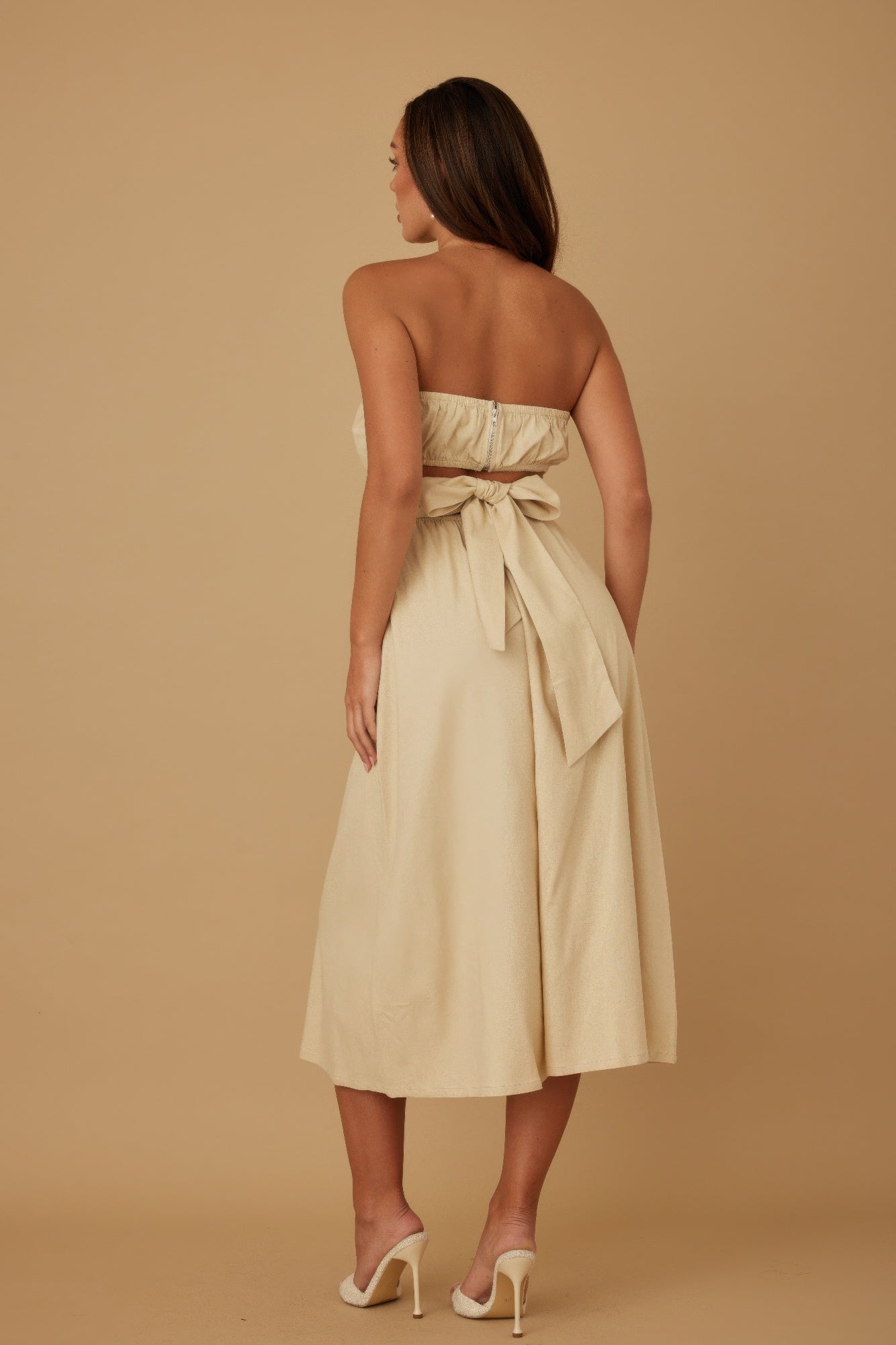 Ivory strapless linen dress, back view with tied waist bow and full skirt