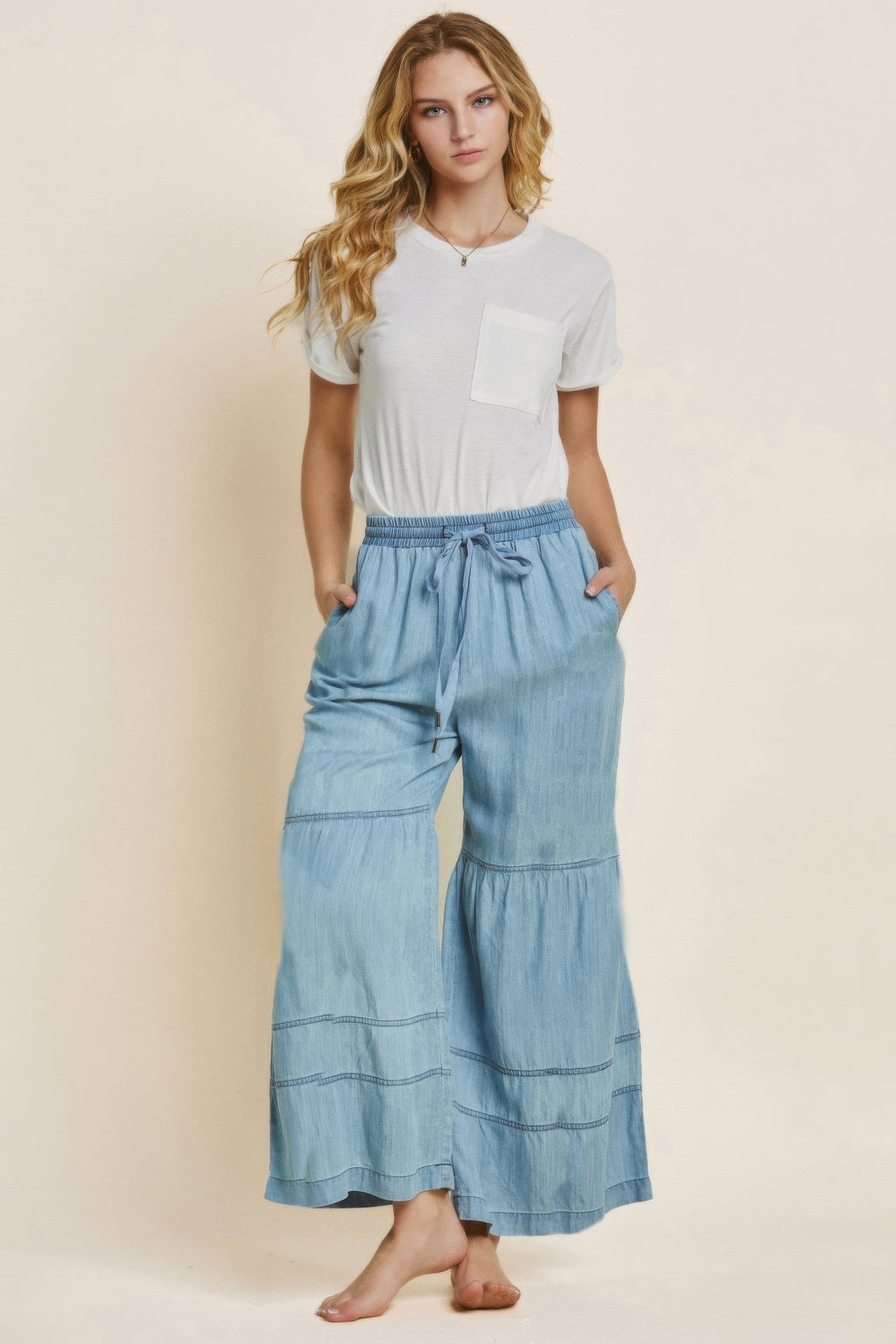 Light-blue washed denim wide-leg pants, tiered panels, elastic drawstring waist
