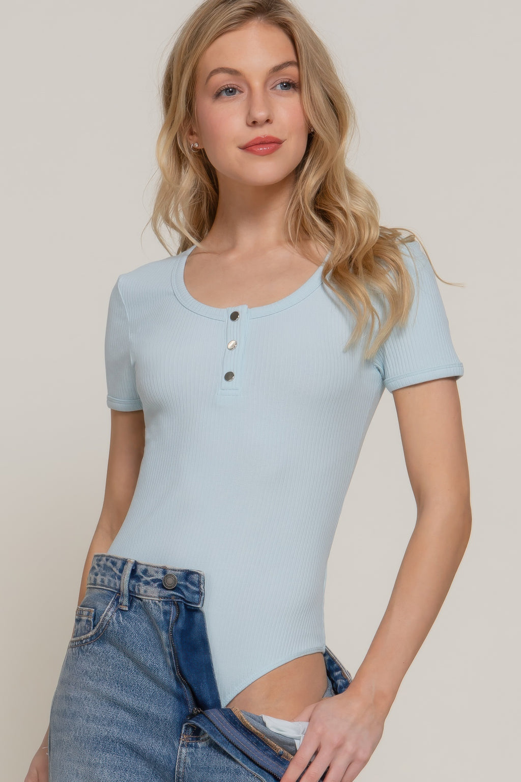 Pale blue ribbed bodysuit with short sleeves, snap-button placket and crew neck
