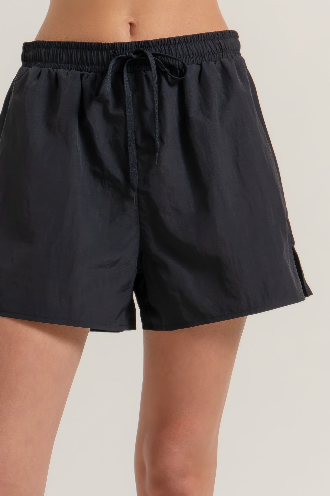 Black anorak side-slit workout shorts with elastic waistband and drawstring tie