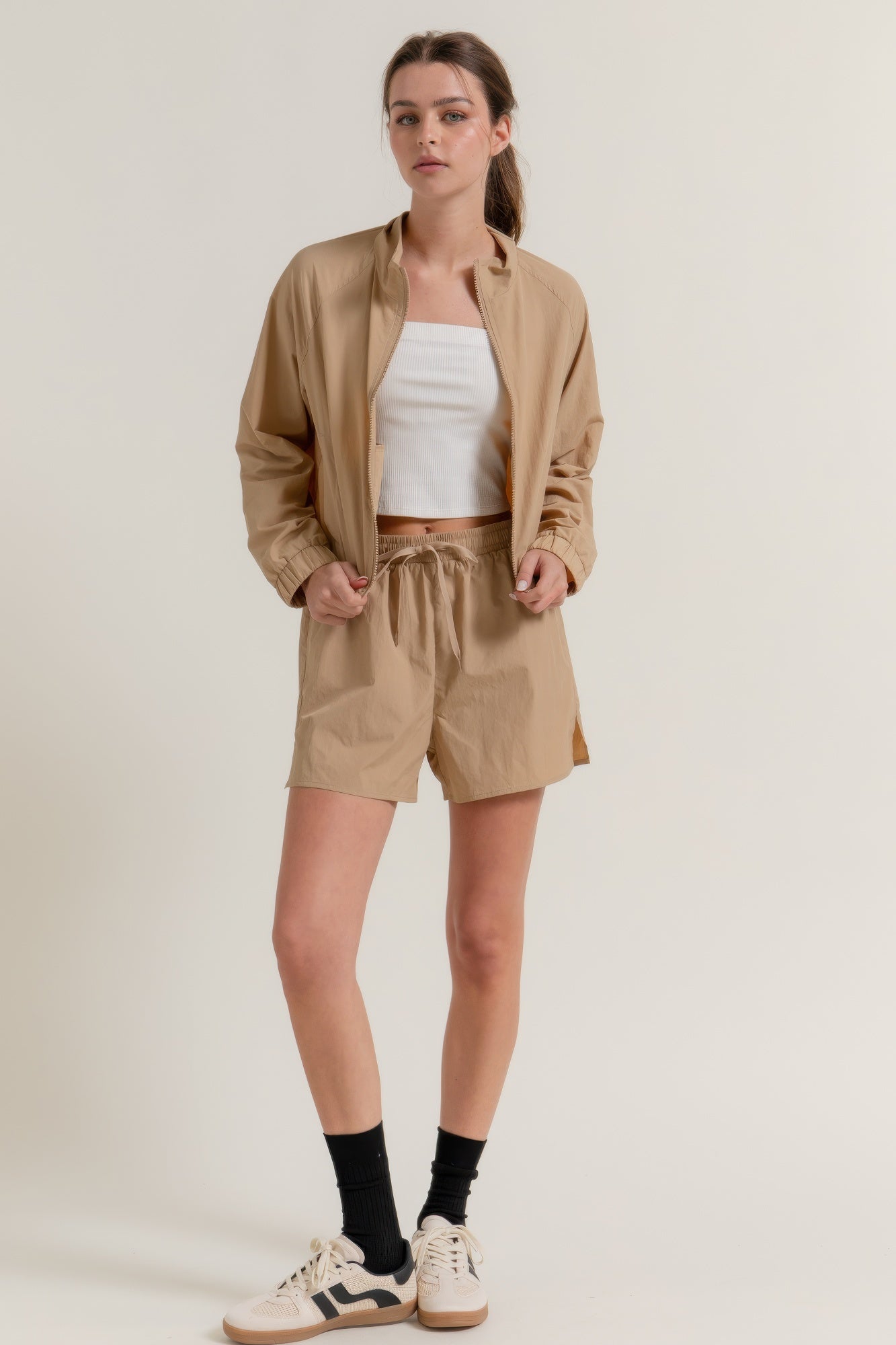 Khaki workout shorts with elastic waist and side slit hems
