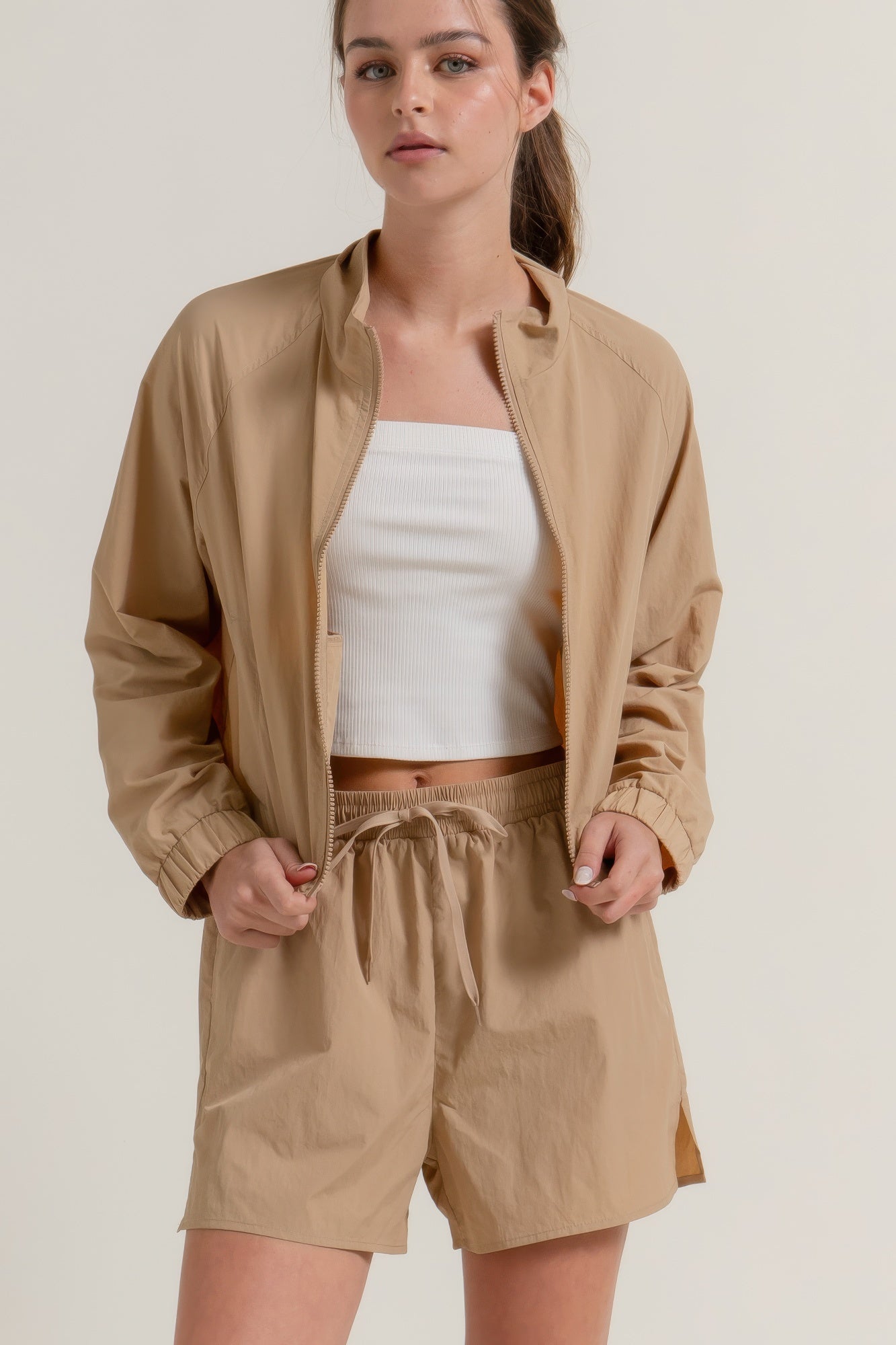 Khaki workout shorts with drawstring waist and side slit hems