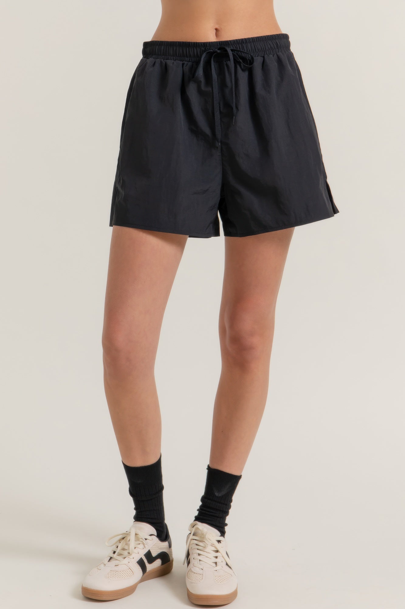 Black side-slit workout shorts, elastic waistband with drawstring and relaxed fit