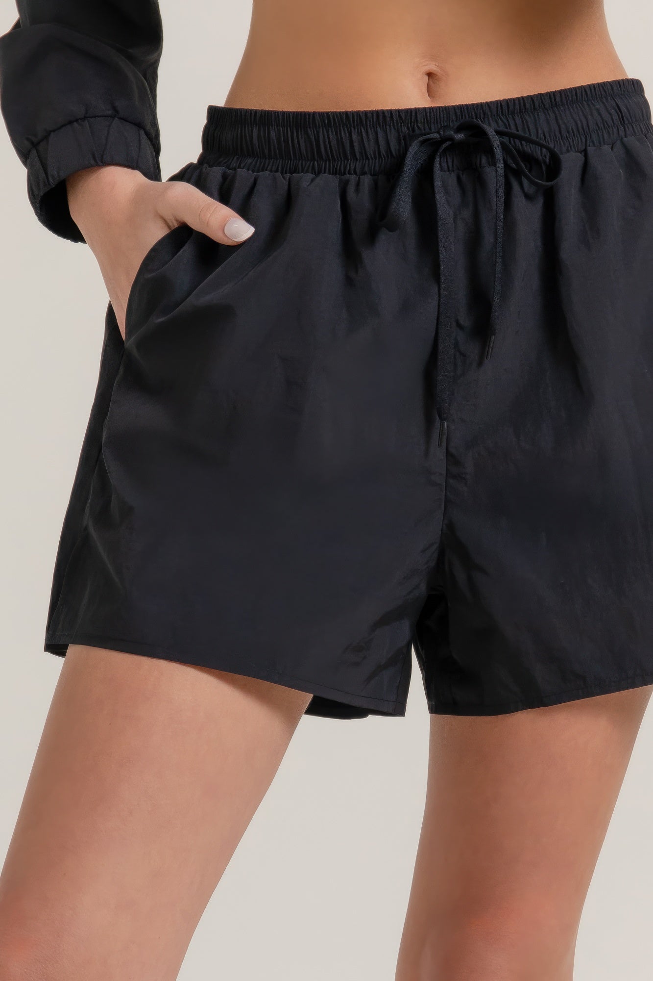 Black side-slit shorts with drawstring waistband and side panel detail