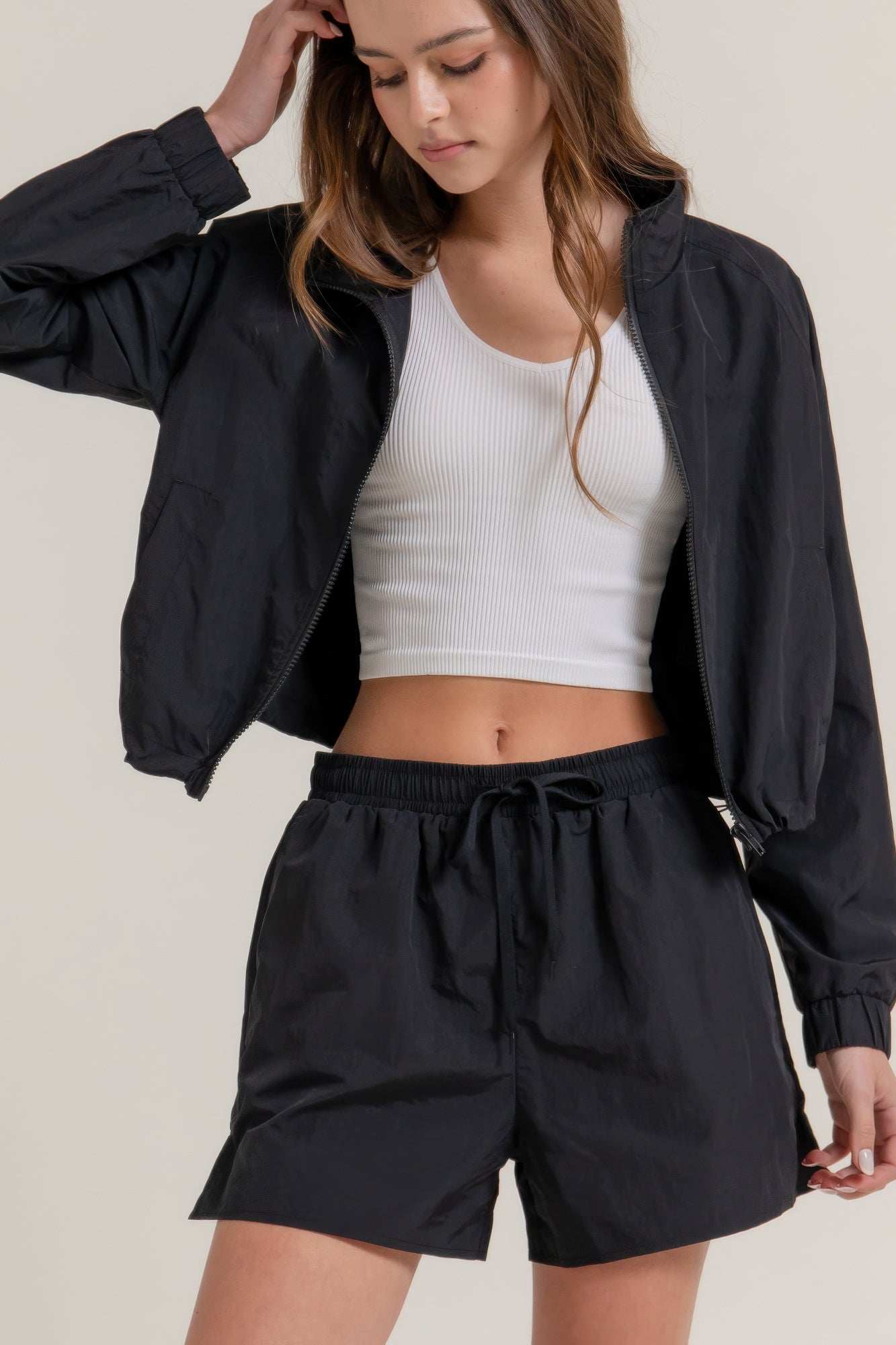 Black workout shorts with elastic waistband and tie, side hem slit detail