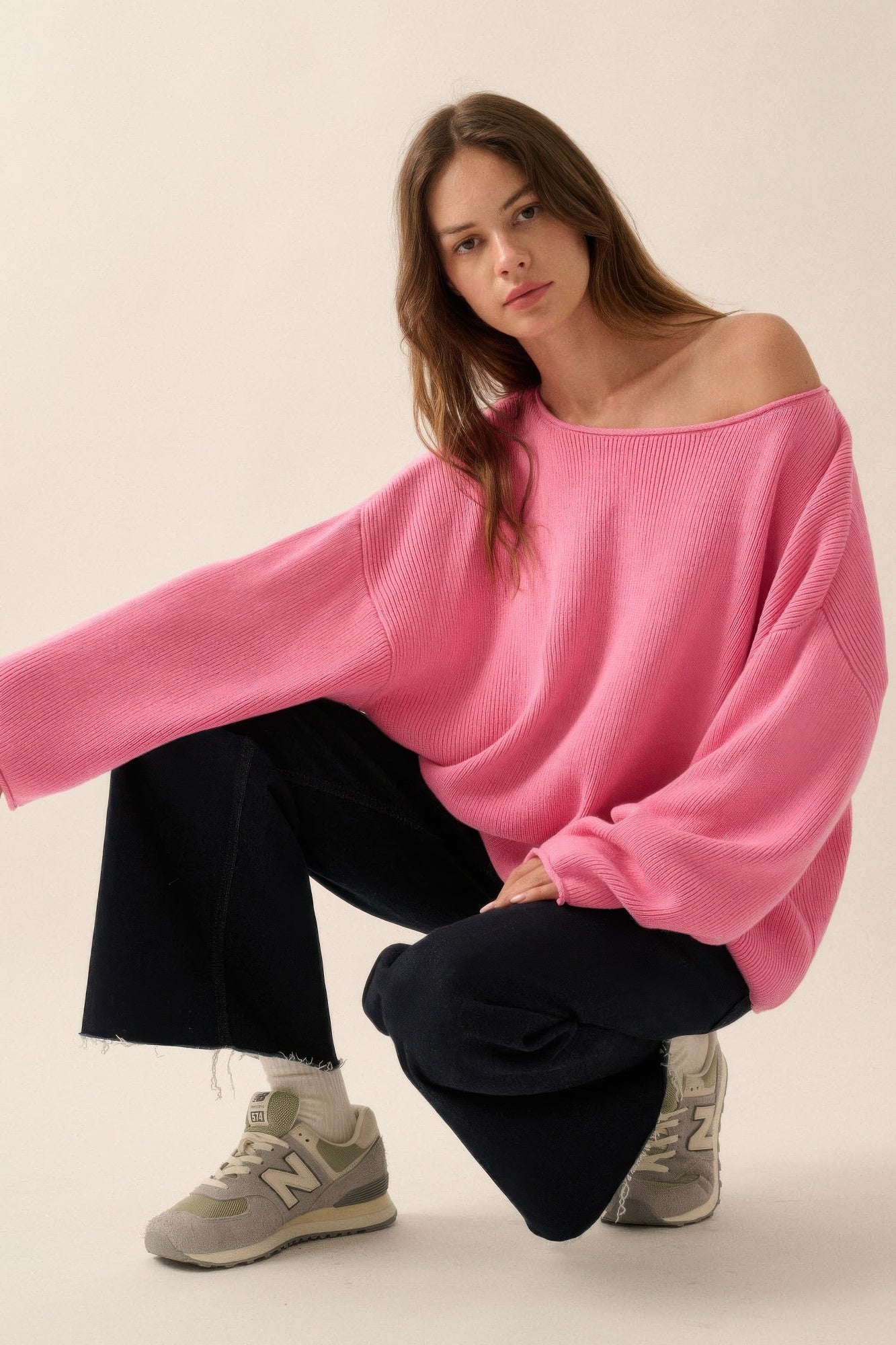 Pink oversized rib-knit boatneck sweater, front view with extended sleeves and relaxed drape