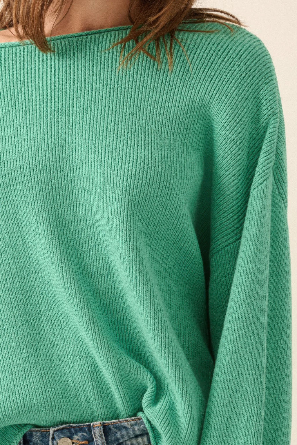 Pine green rib-knit sweater fabric close-up at boatneck and sleeve cuff