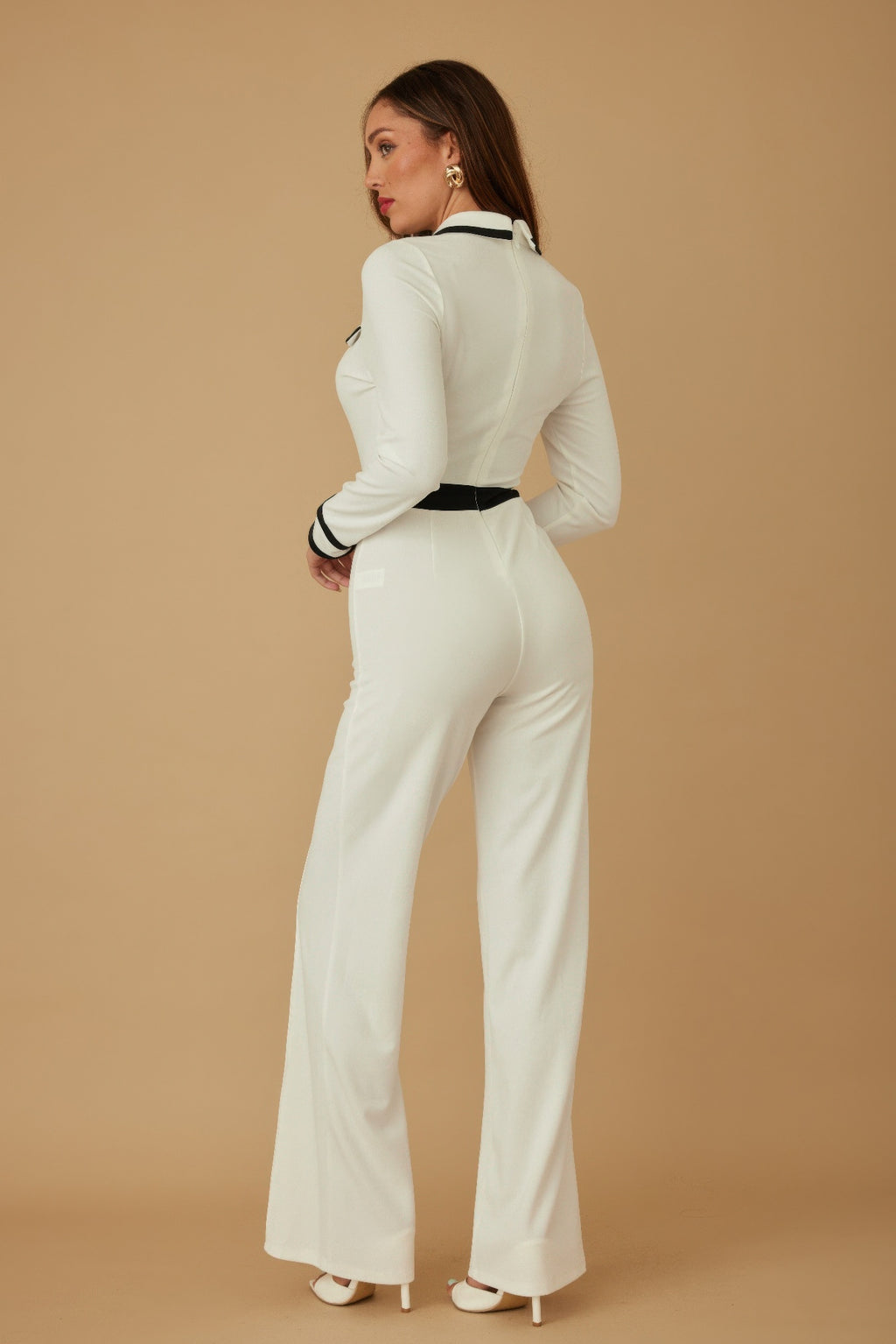 Cream-white jumpsuit back view with black waist belt and striped sleeve cuffs