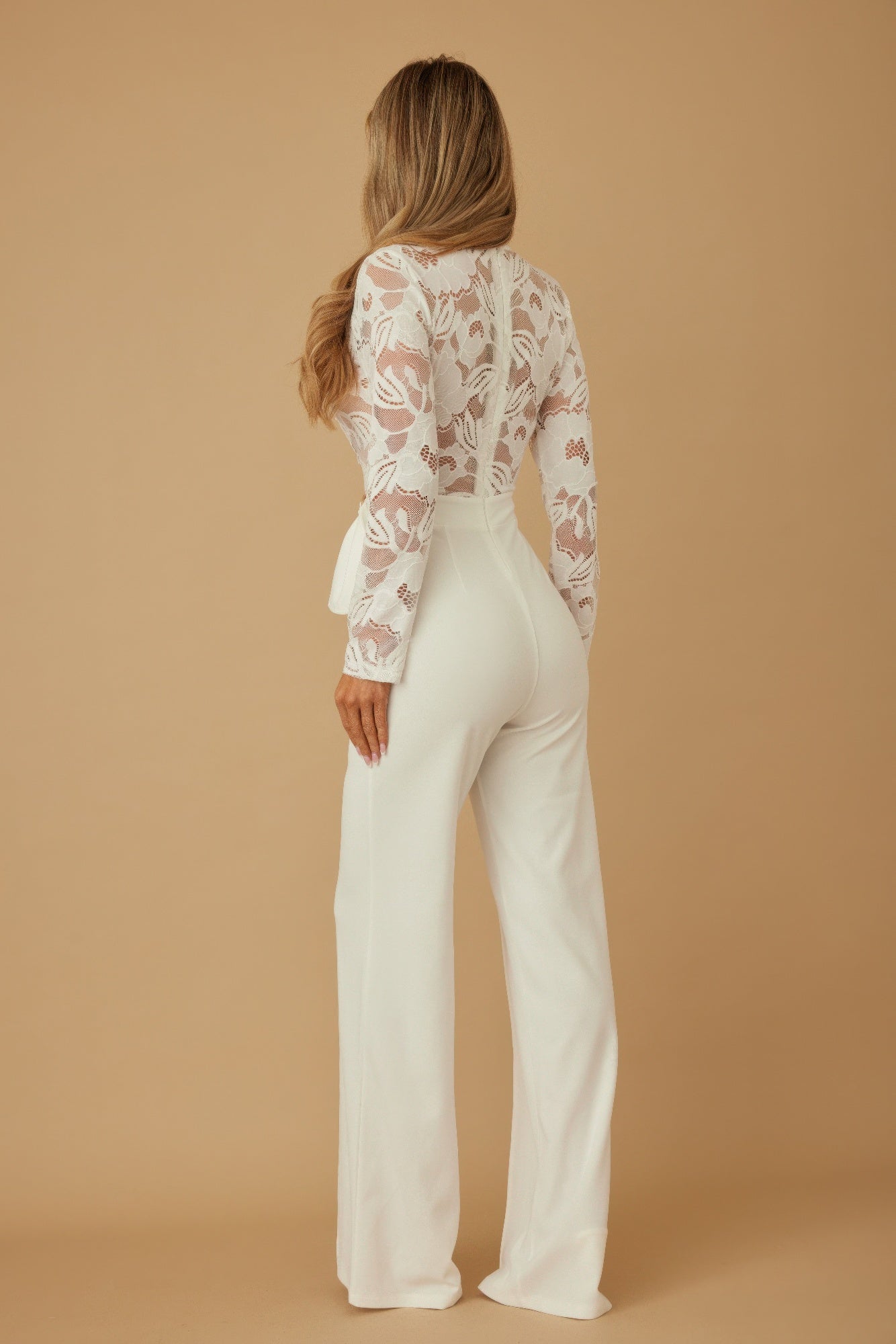 Back view: white lace crochet jumpsuit with long sleeves and wide-leg pants