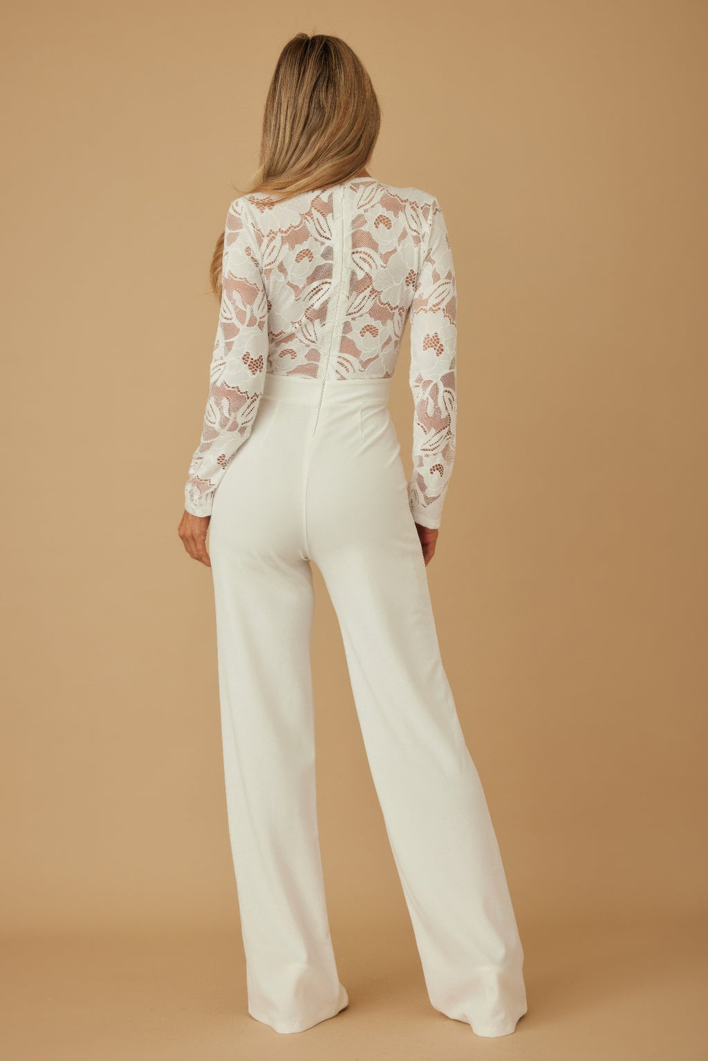 Back view: white lace crochet long-sleeve jumpsuit with center seam and wide legs