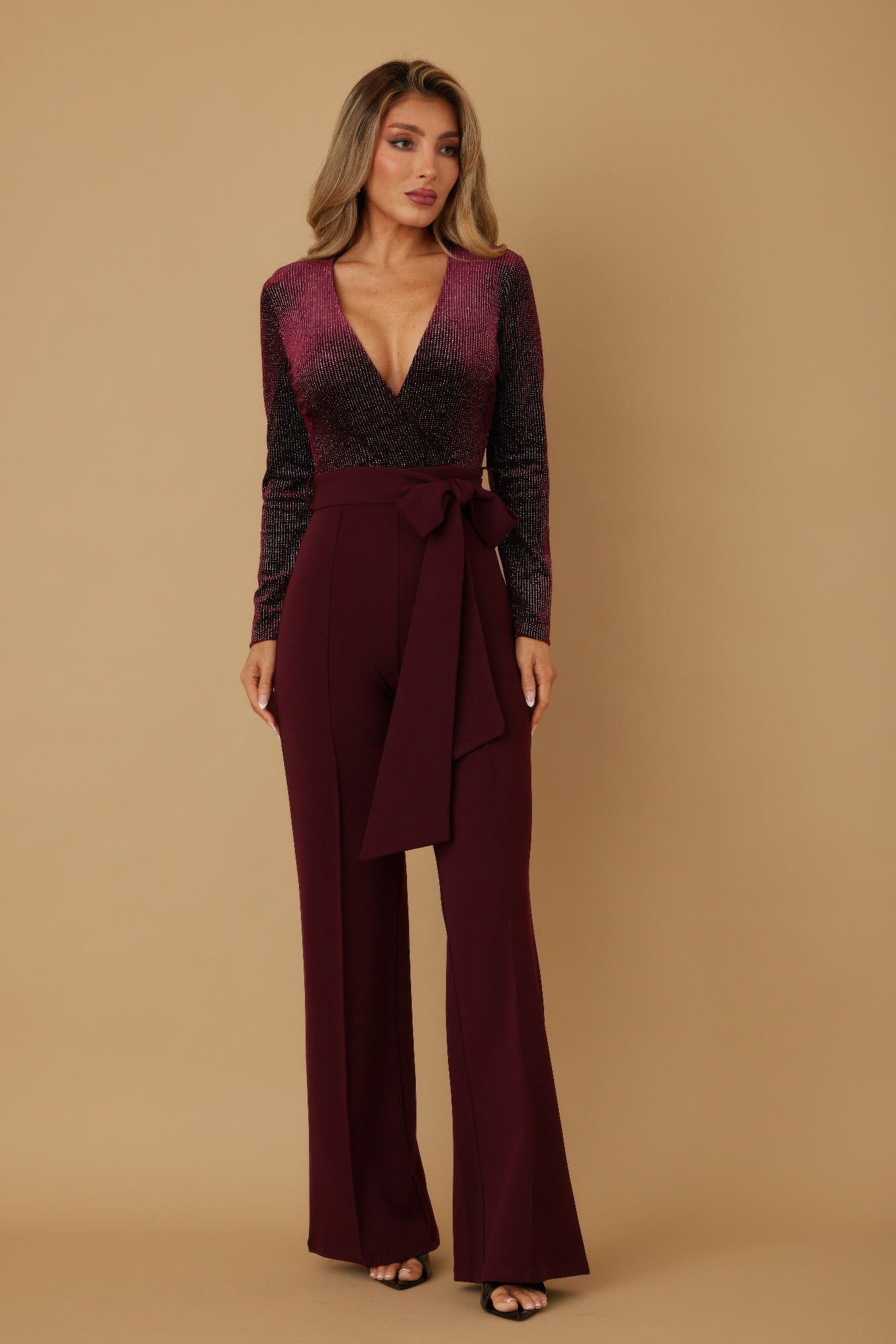 Wine velvet top fashion jumpsuit, front view with draped waist tie and flared wide legs