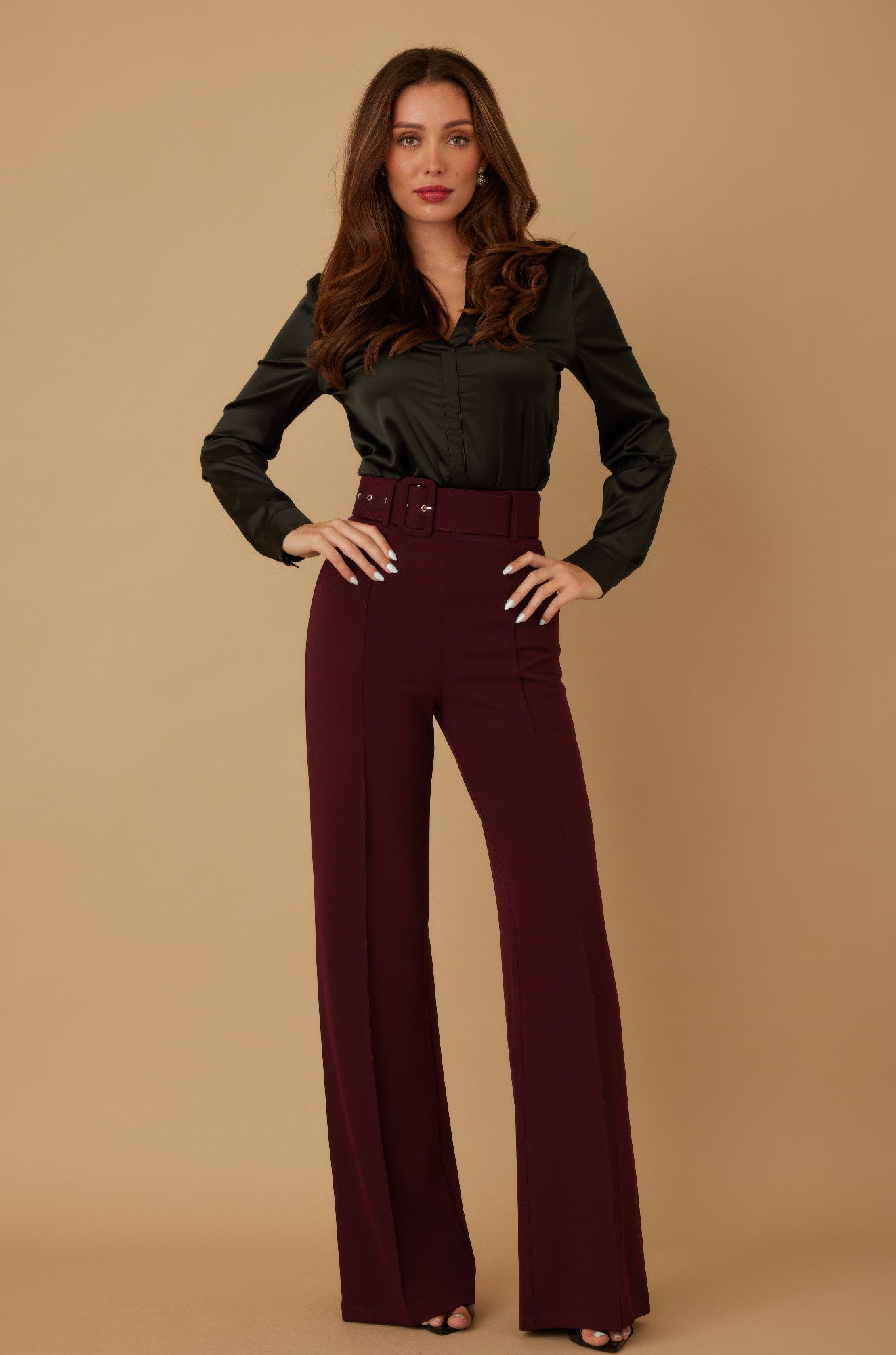 Wine-colored high-waist pants with buckle belt and wide flared legs.