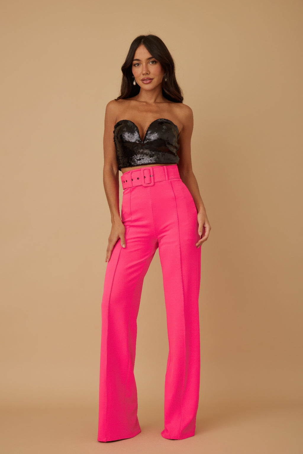 High-waist fuchsia pants with buckle belt, wide-leg silhouette.