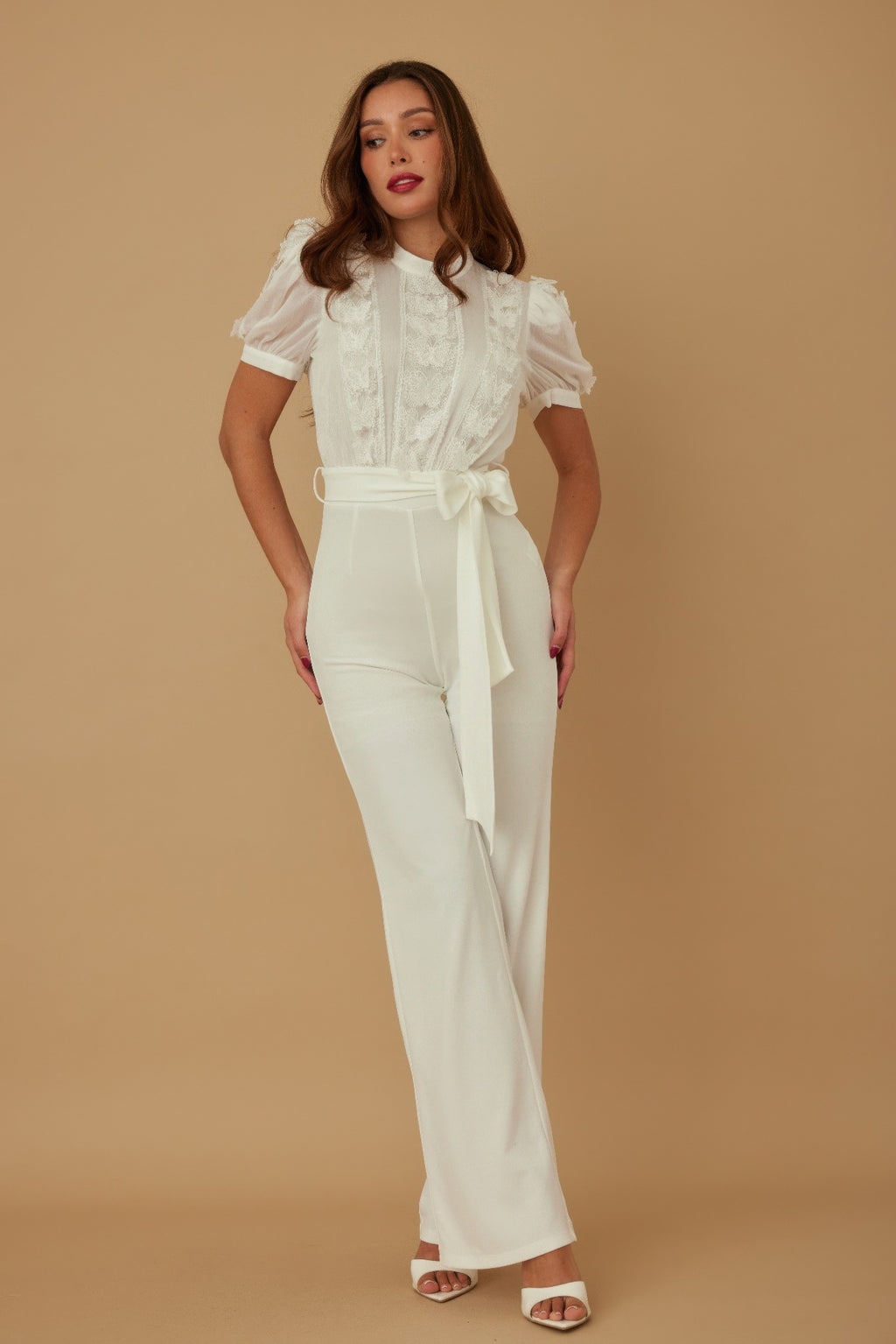 White jumpsuit with sheer patterned top, puff sleeves, self-tie belt, wide legs