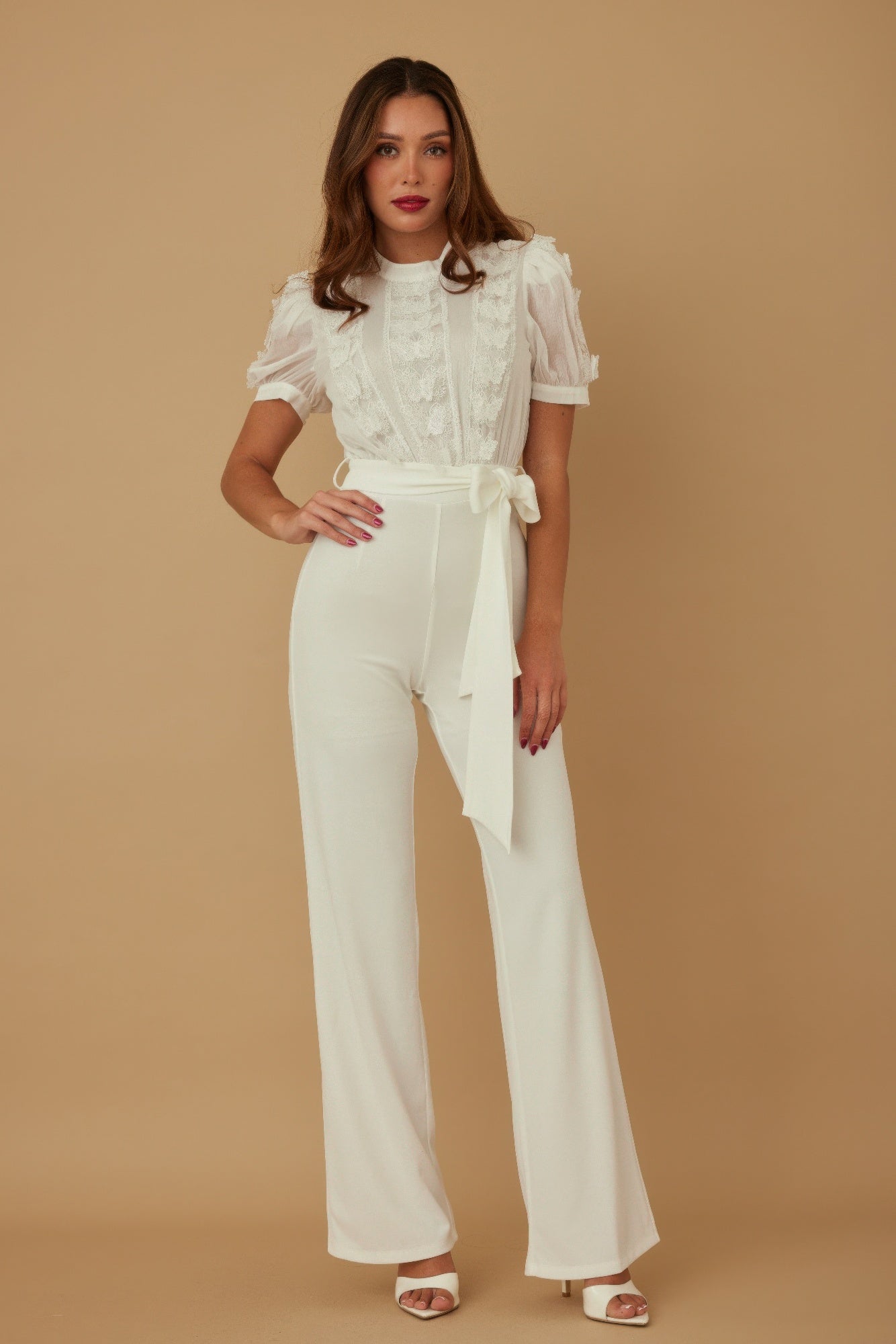 White sheer jumpsuit with textured front, puff sleeves, draped waist tie, wide legs