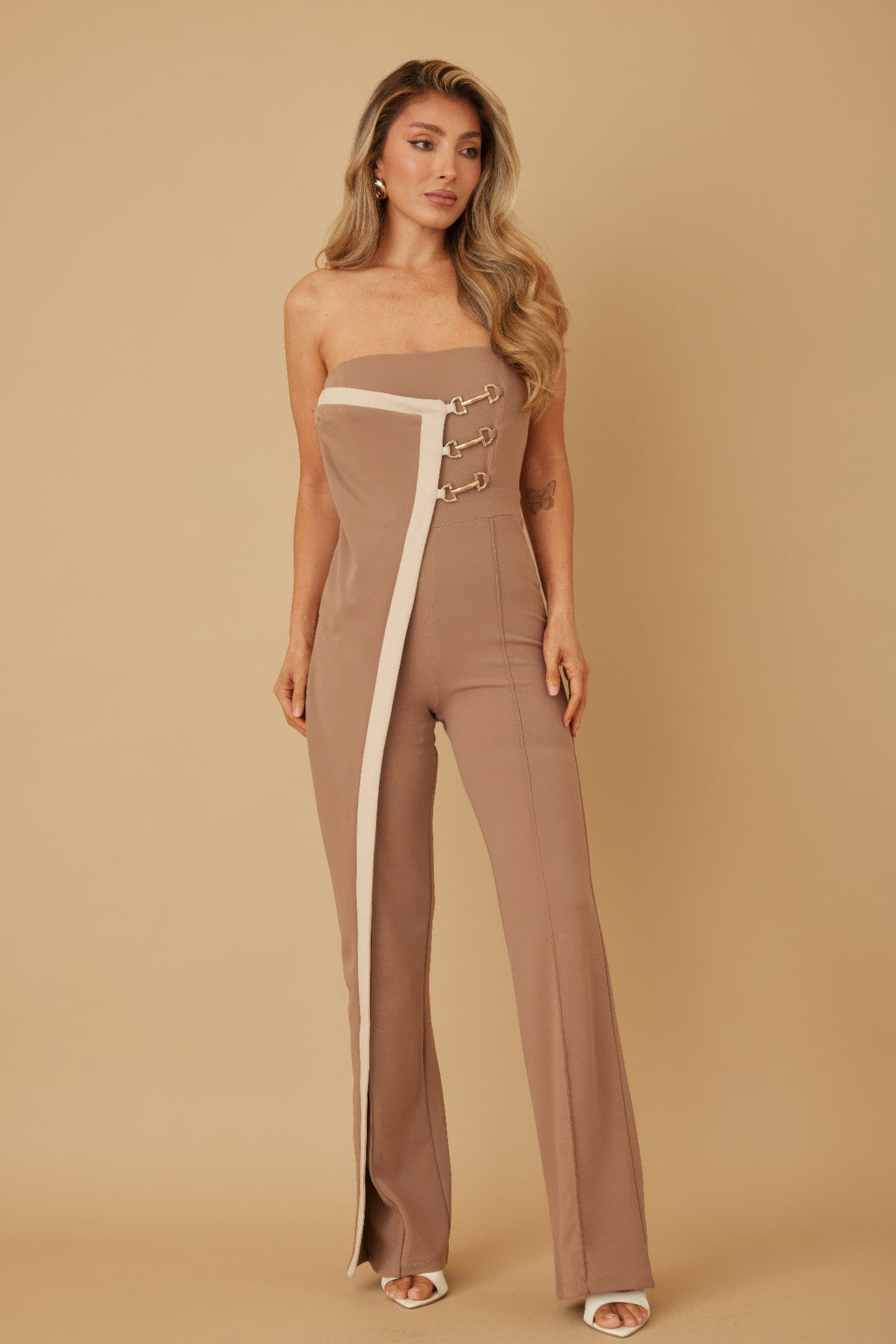 Taupe strapless flap jumpsuit with white panel and gold chain-buckle detail