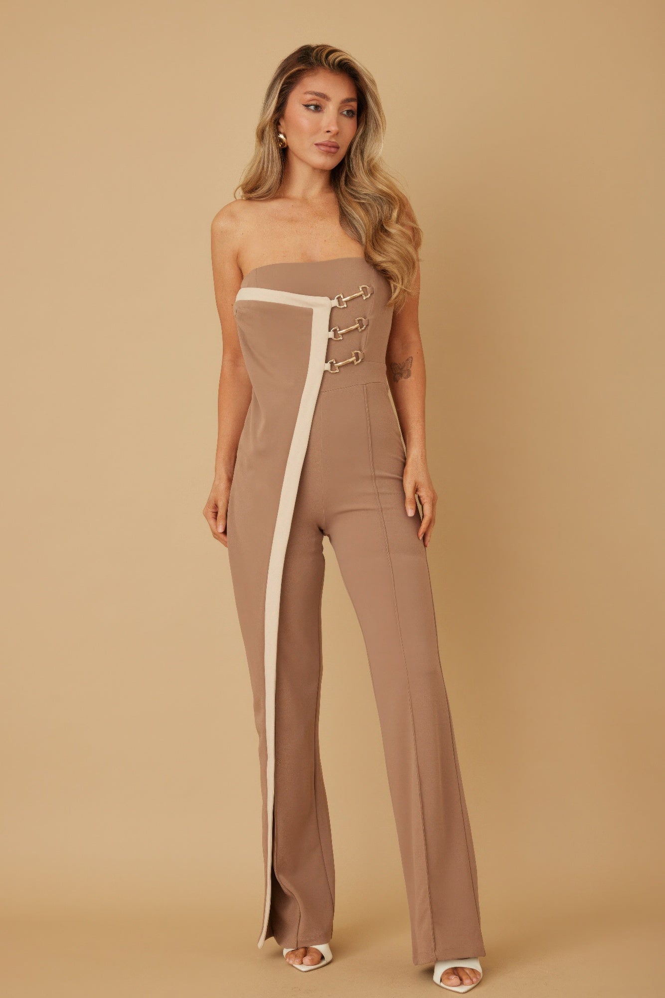 Taupe strapless flap jumpsuit with white panel and gold chain-buckle detail