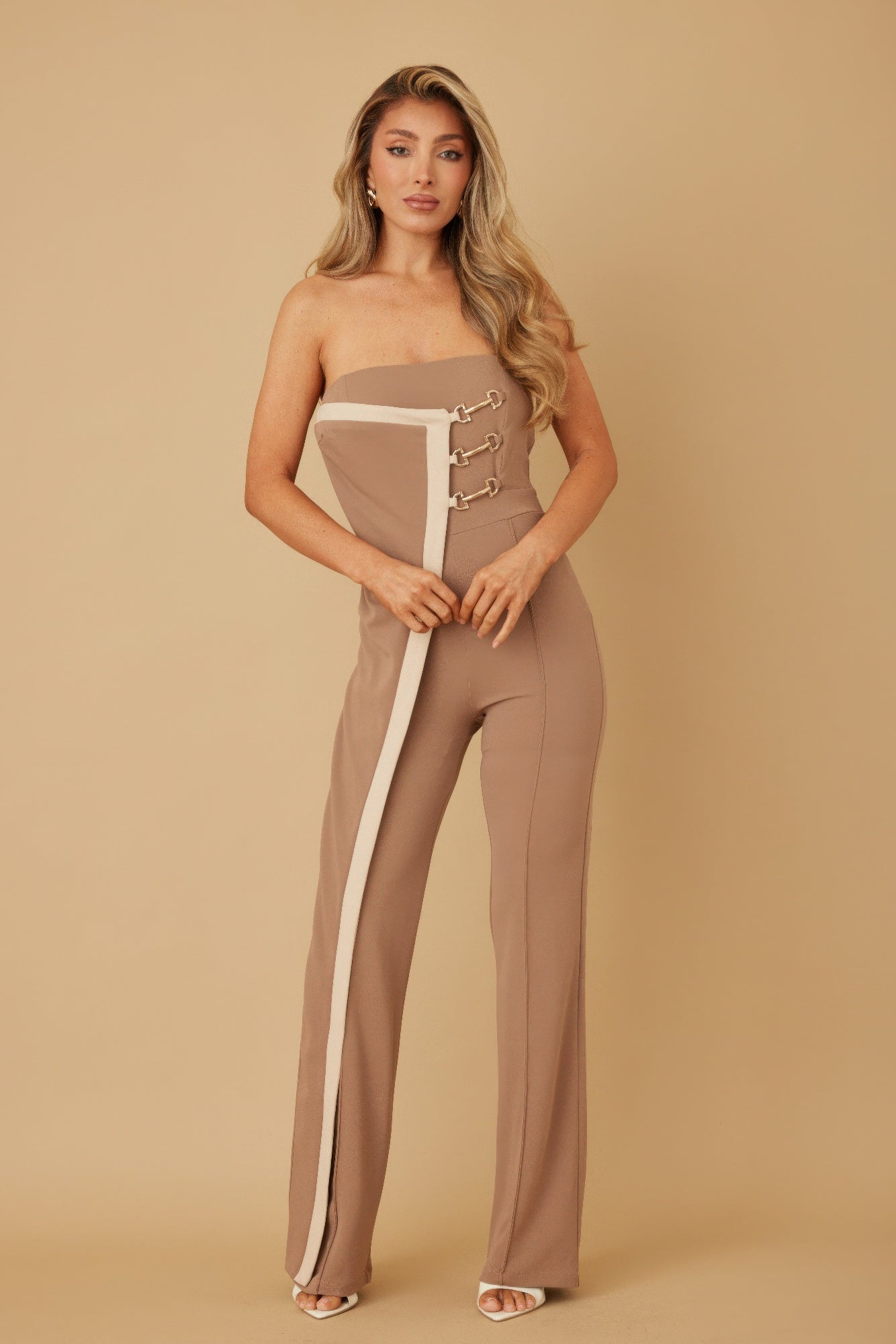 Taupe strapless jumpsuit with white side panels and gold chain closure