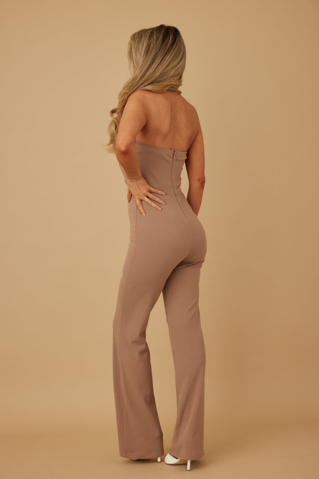 Back view: taupe strapless jumpsuit with open back and minimal seams