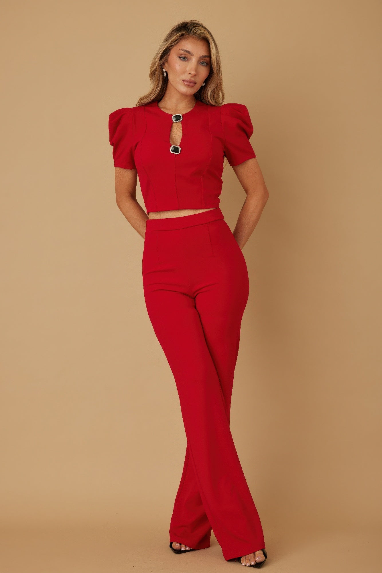 Red high-rise pants with wide legs and matching puff cap sleeve crop top set