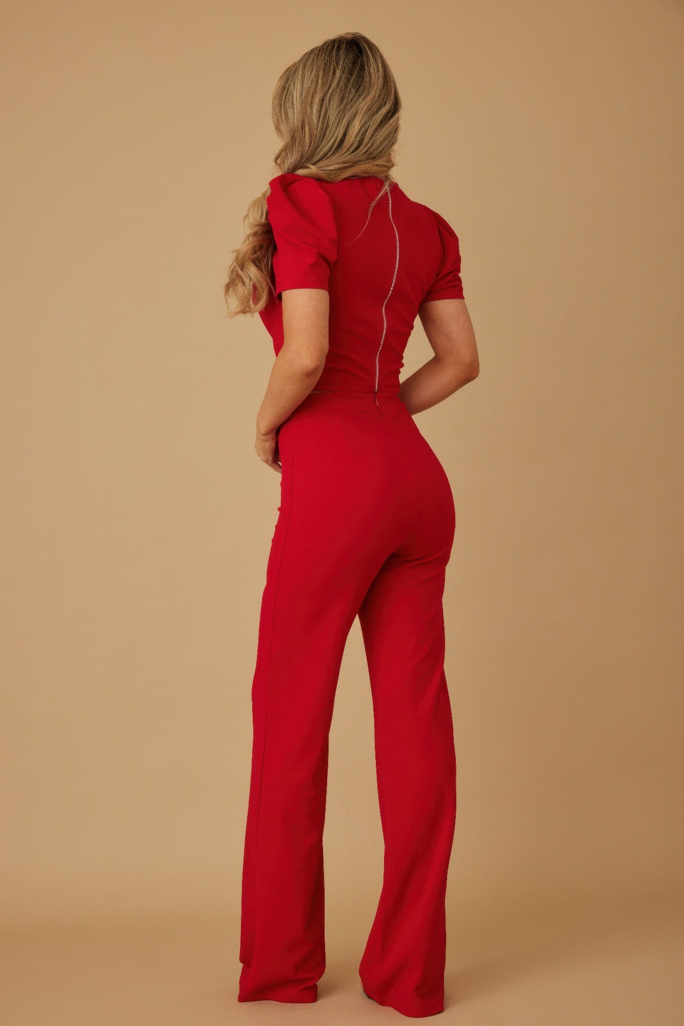 Back view of red matching set: puff cap sleeve crop top and wide-leg pants