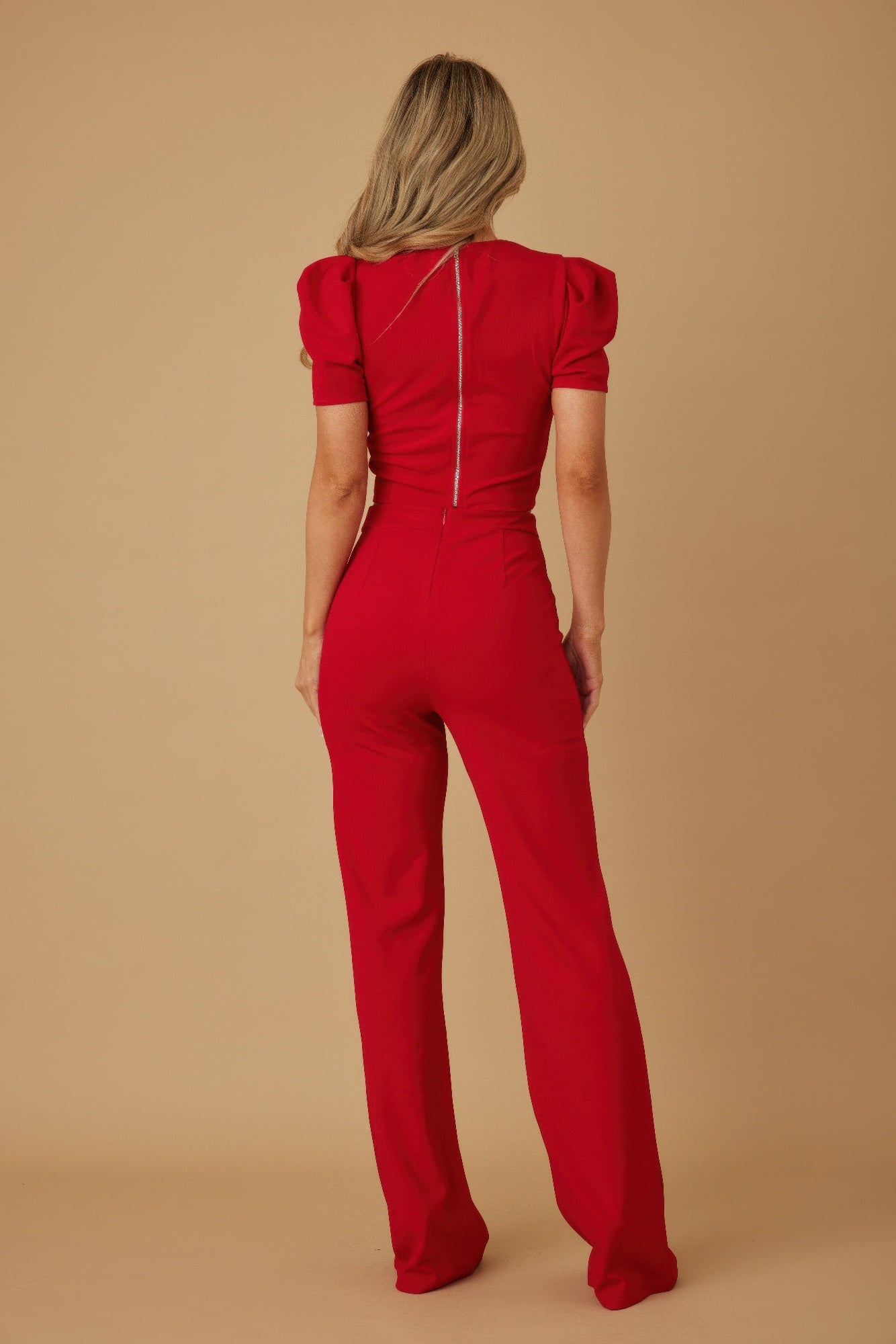 Back view of red two-piece set with center-back seam on crop top and pants