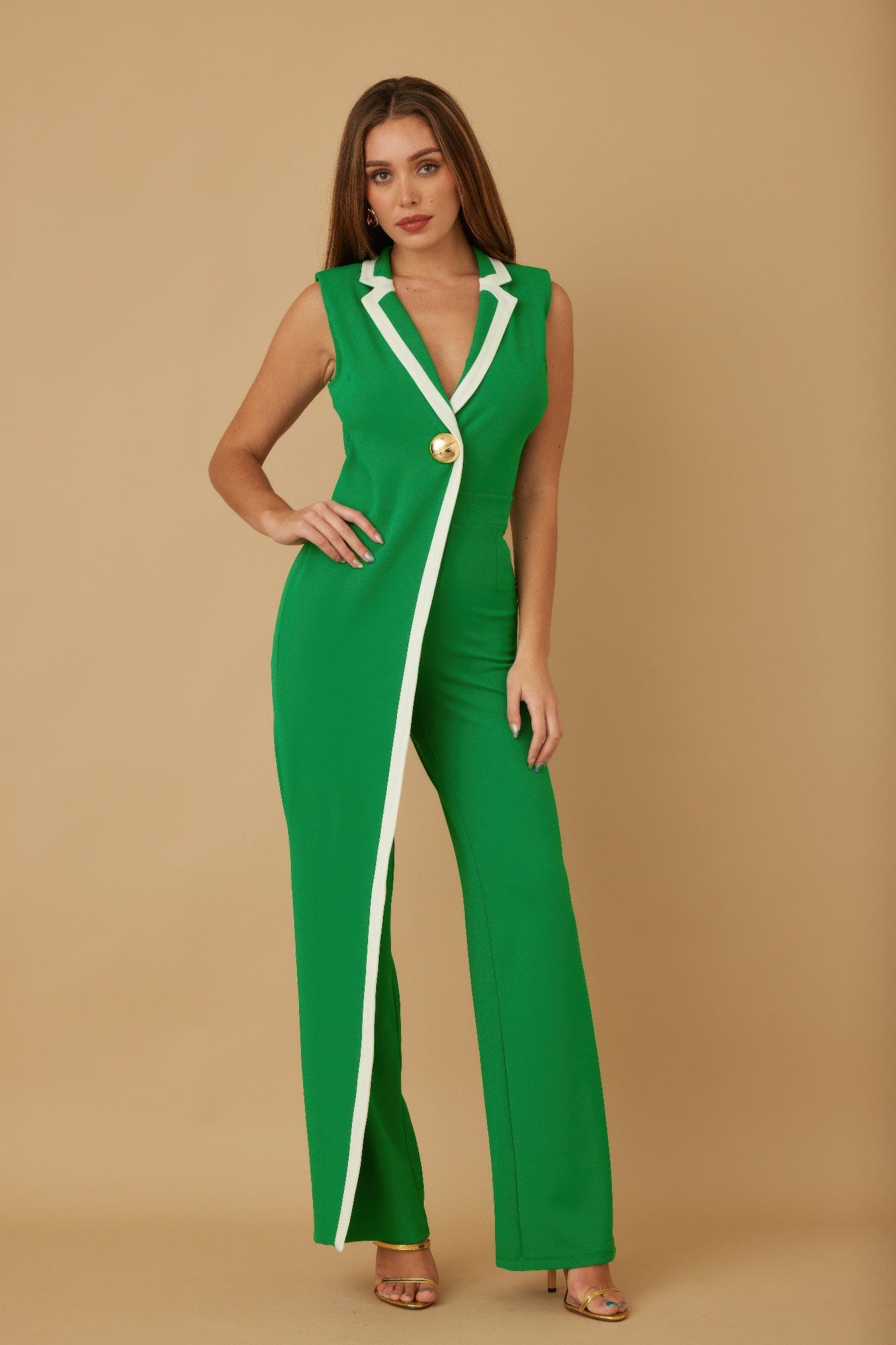 Green sleeveless jumpsuit with V-neck, white trim, and gold button front