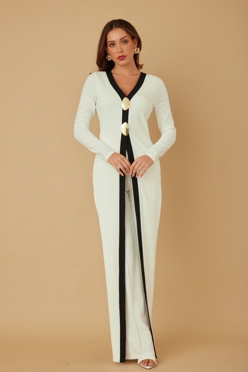 Cream long layer jumpsuit with black V-neck trim and gold mirror-stone button detail down front