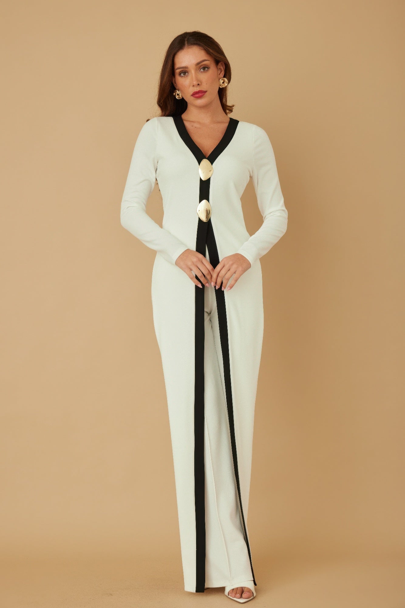 Cream long layer jumpsuit with black V-neck trim and gold mirror-stone button detail down front