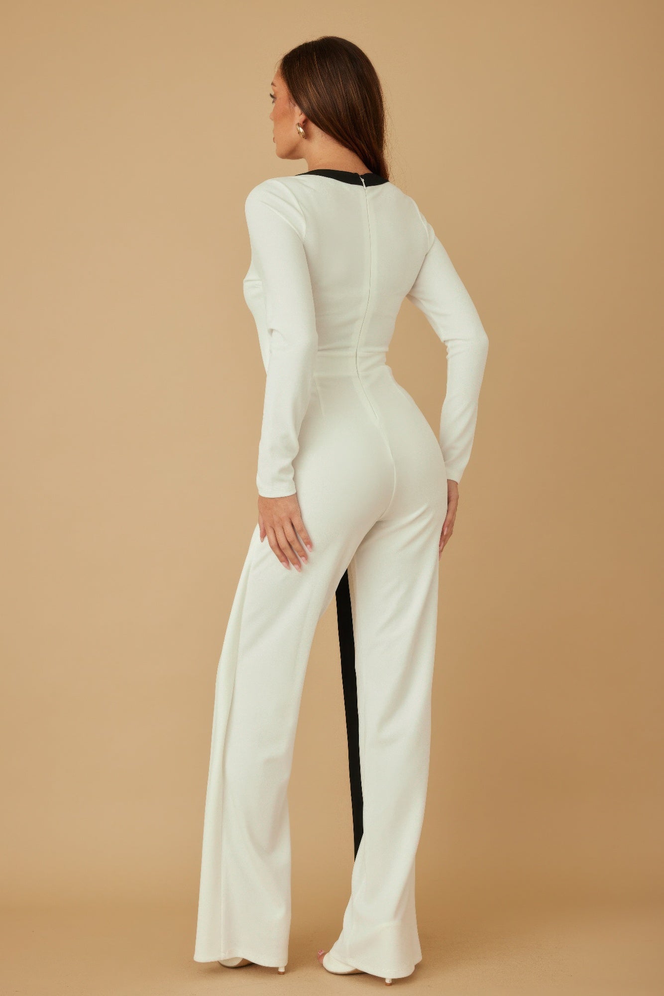 Back view cream long layer jumpsuit with long sleeves and fitted waist seam details
